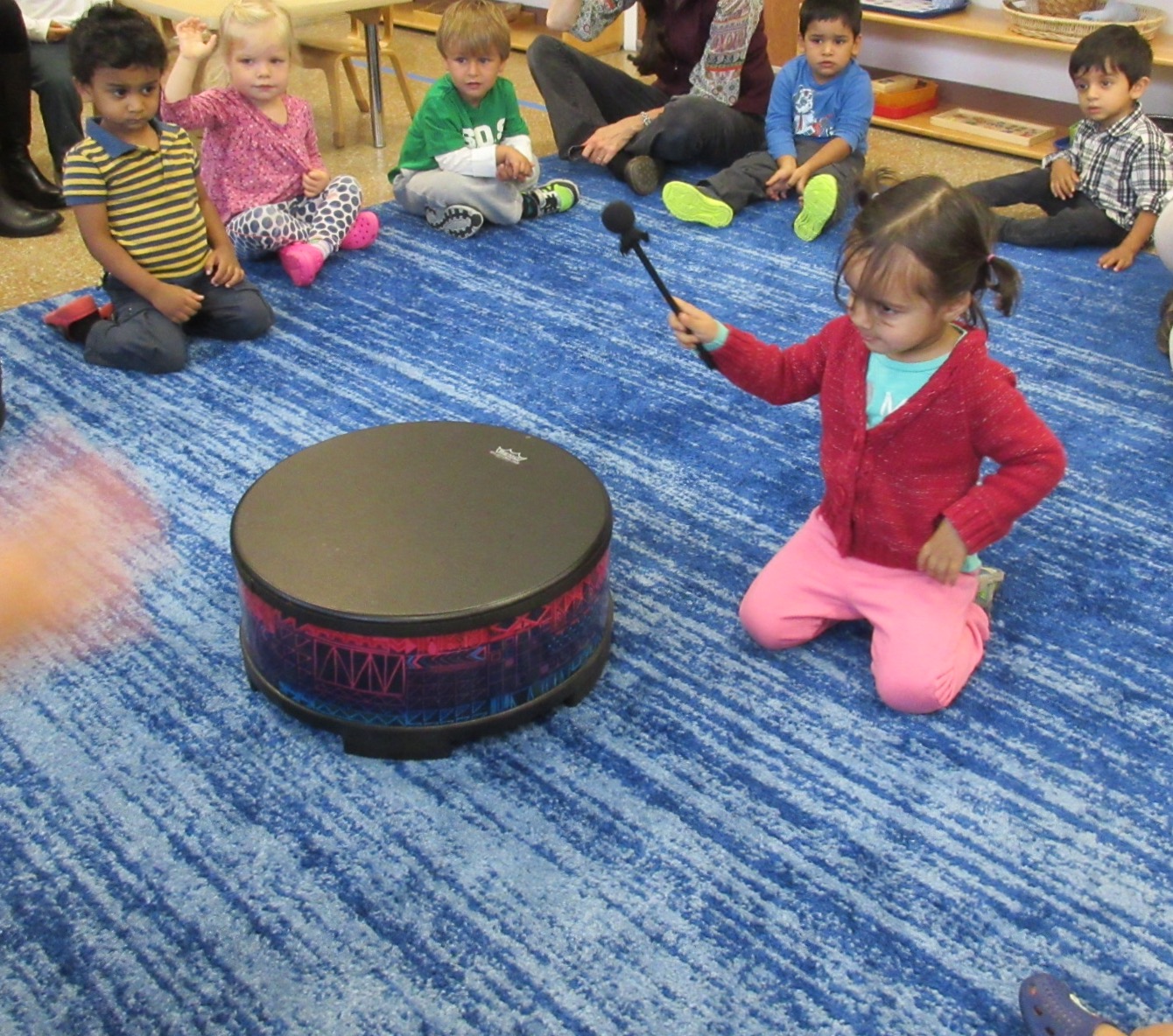 Taking turns using the drum in Music class