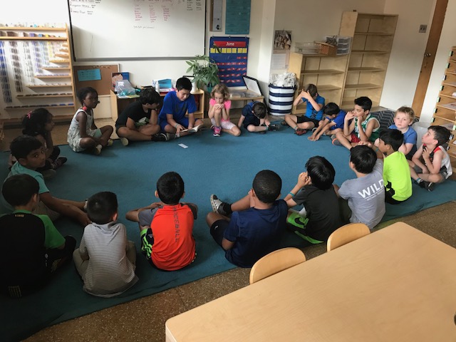 Older friends reading Charlottes Web to everyone 