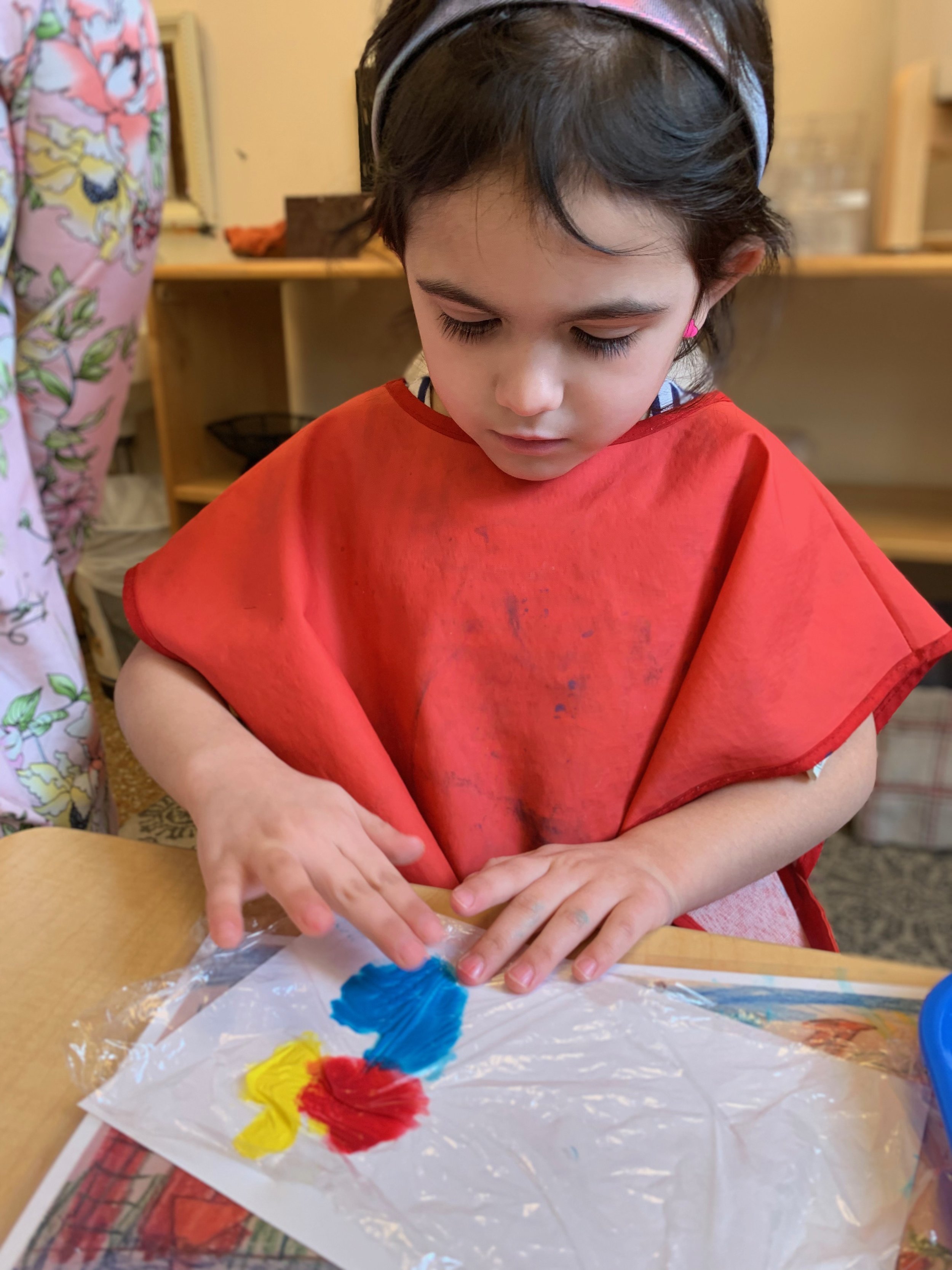 Process art- spreading paint under plastic wrap