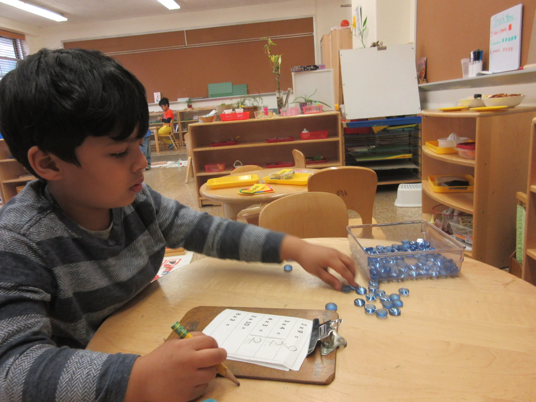 Practicing multiplication problems using the counters.
