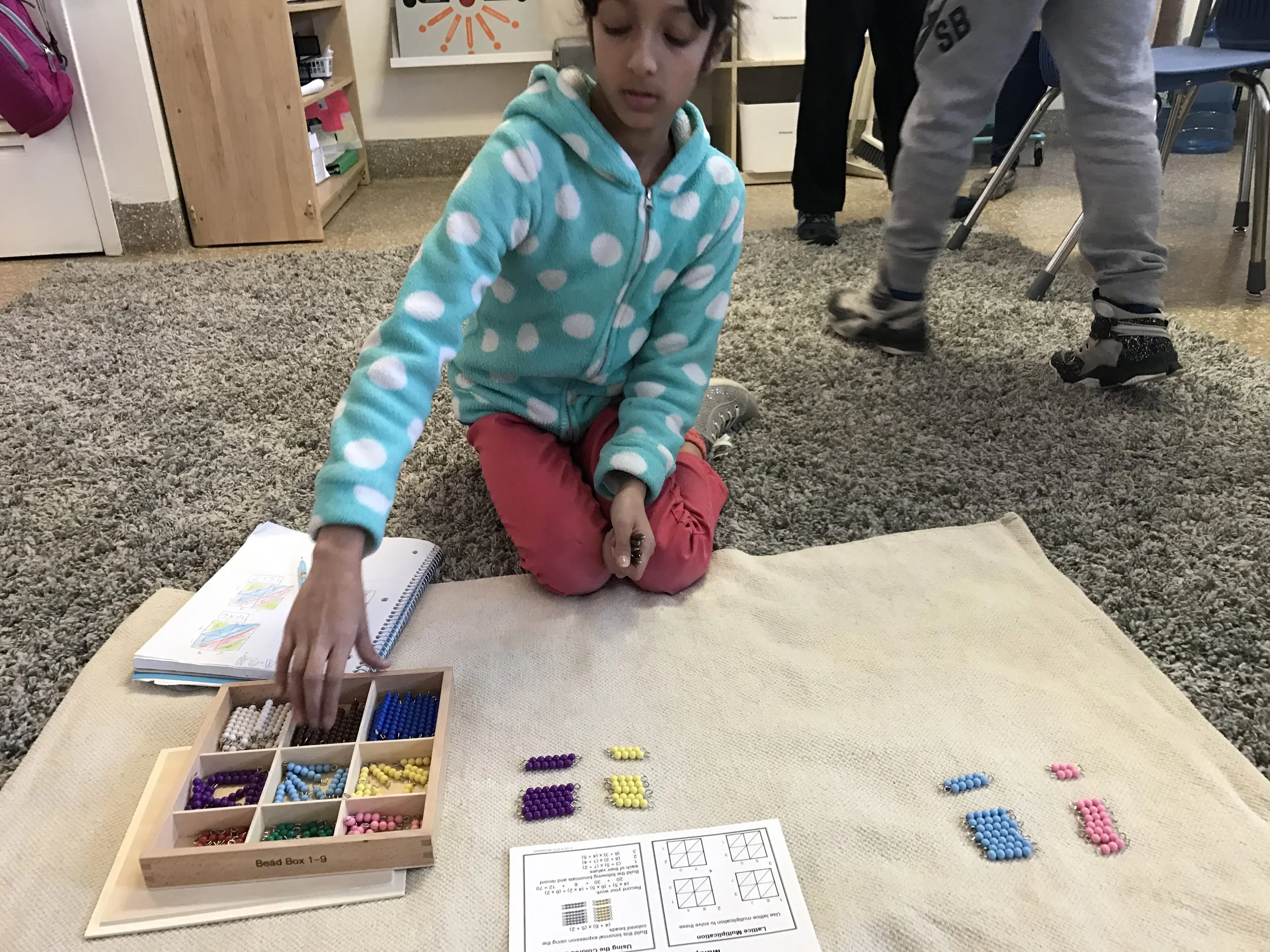 Perseus Room friend learning binomials through colored beads in Mathematics 