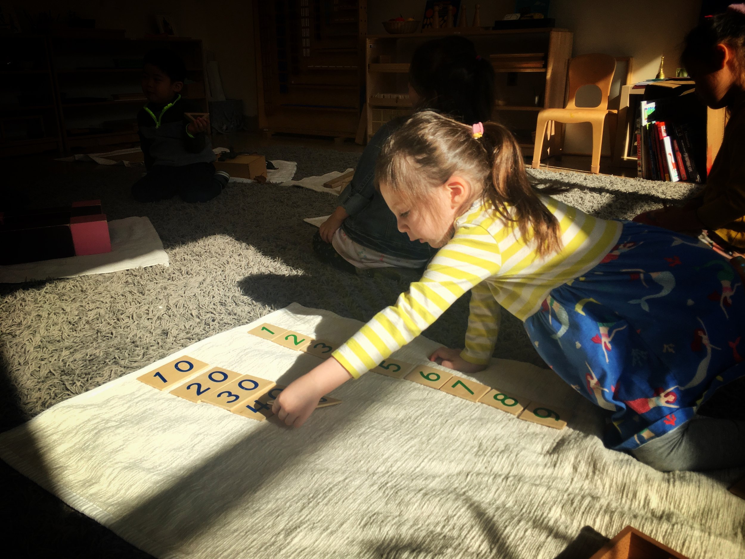 Laying out the sequence of units, tens, hundreds and thousands in preliminary place value work