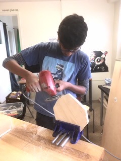 Arjun using power sander.jpg