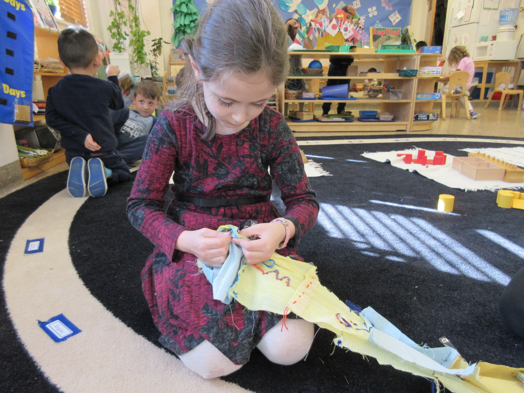 Working on a two week project- sewing a "We <3 Montessori" banner