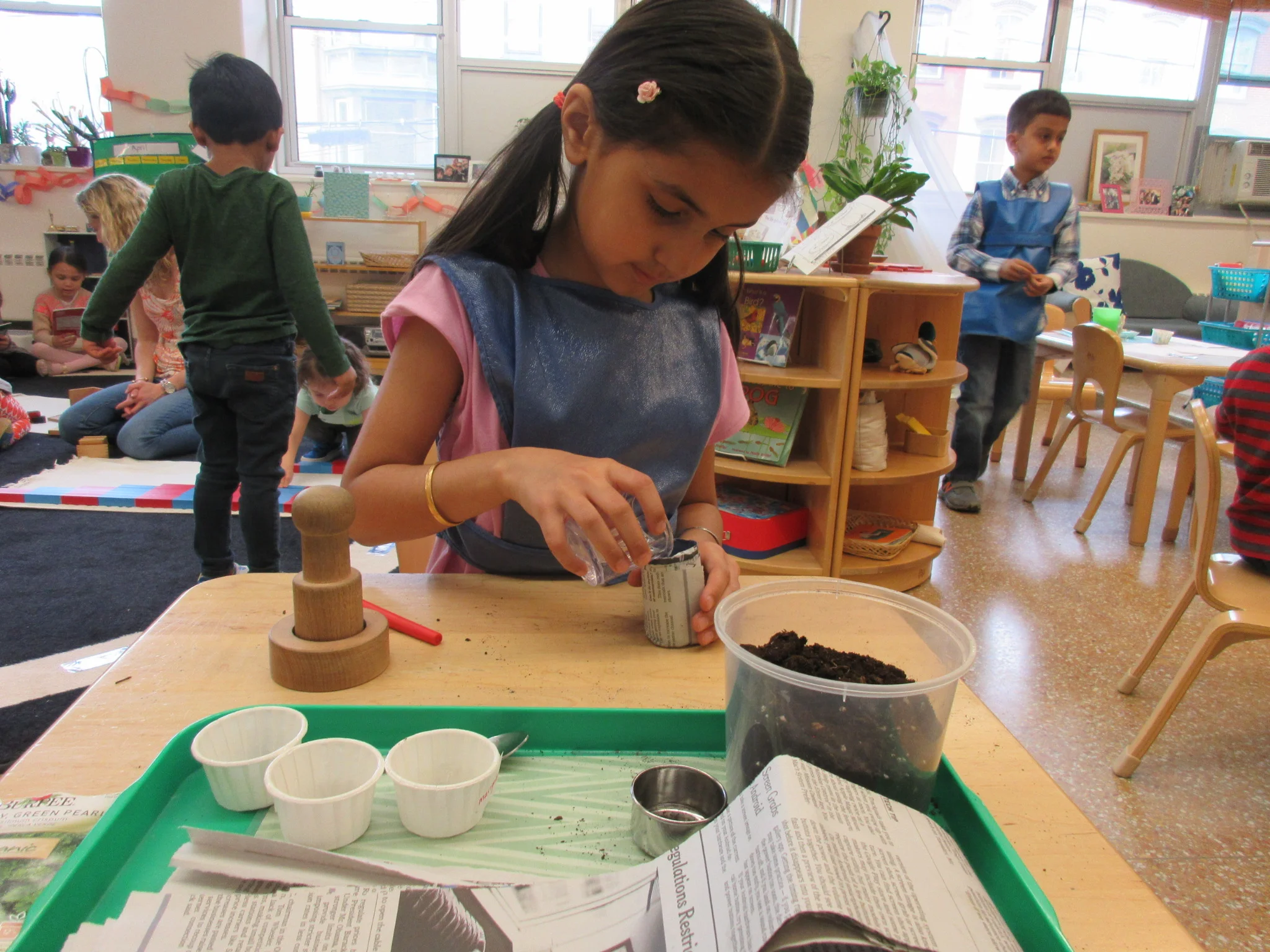 Making a newspaper flower pot and planting seeds 