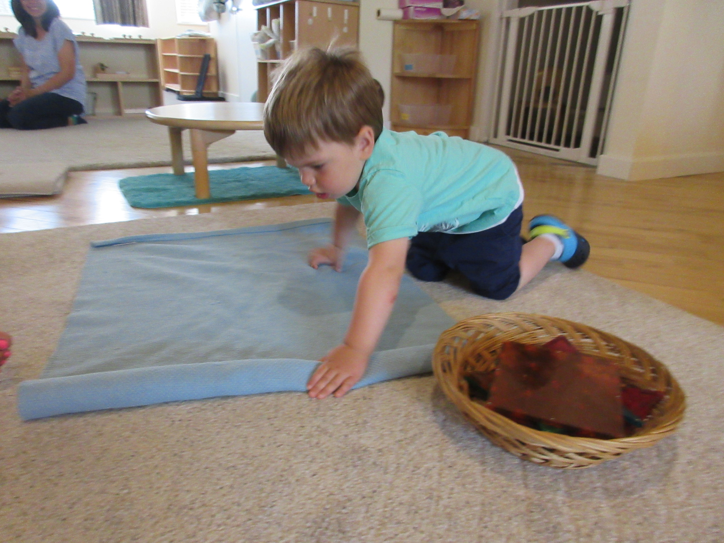 Carefully unrolling our work rug.
