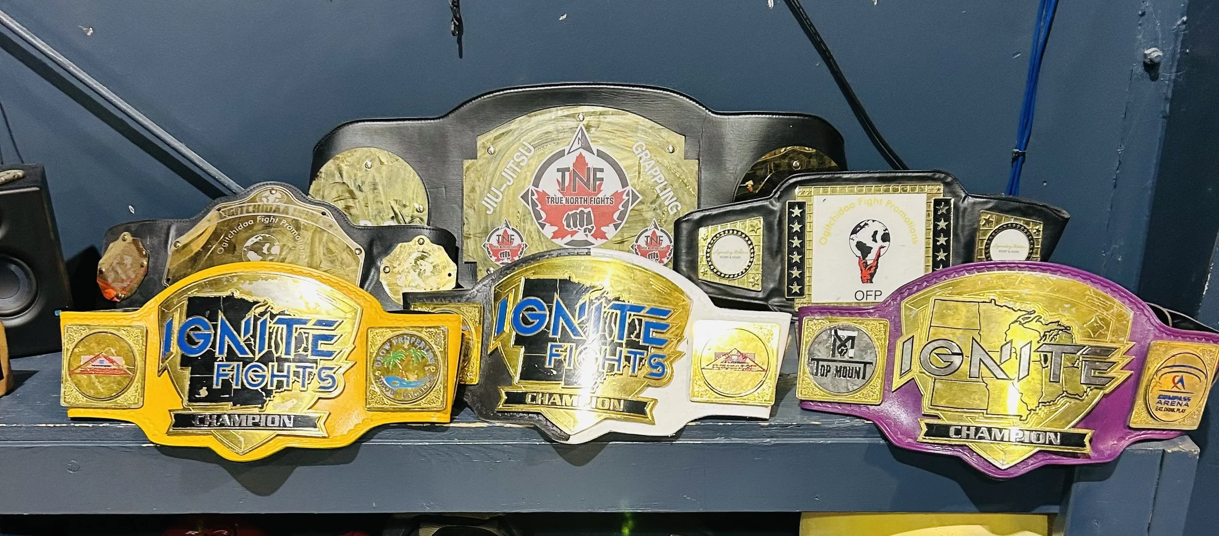 Leading Edge Competition Team Championship belts in MMA and one in Grappling.