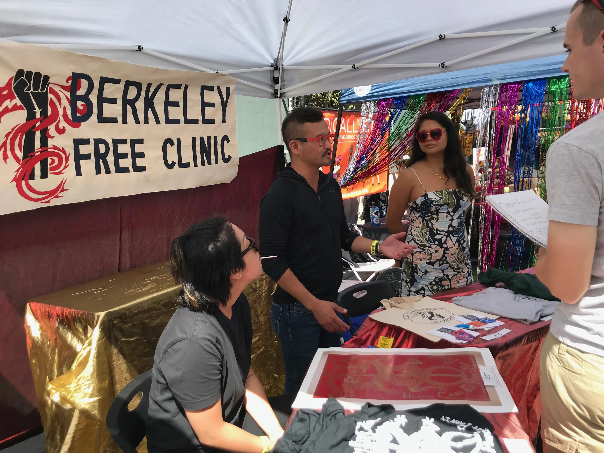 Oakland Pride booth L to r: Ames (PCC), Daniel (GMHC/PCC), and Kama (HPS)