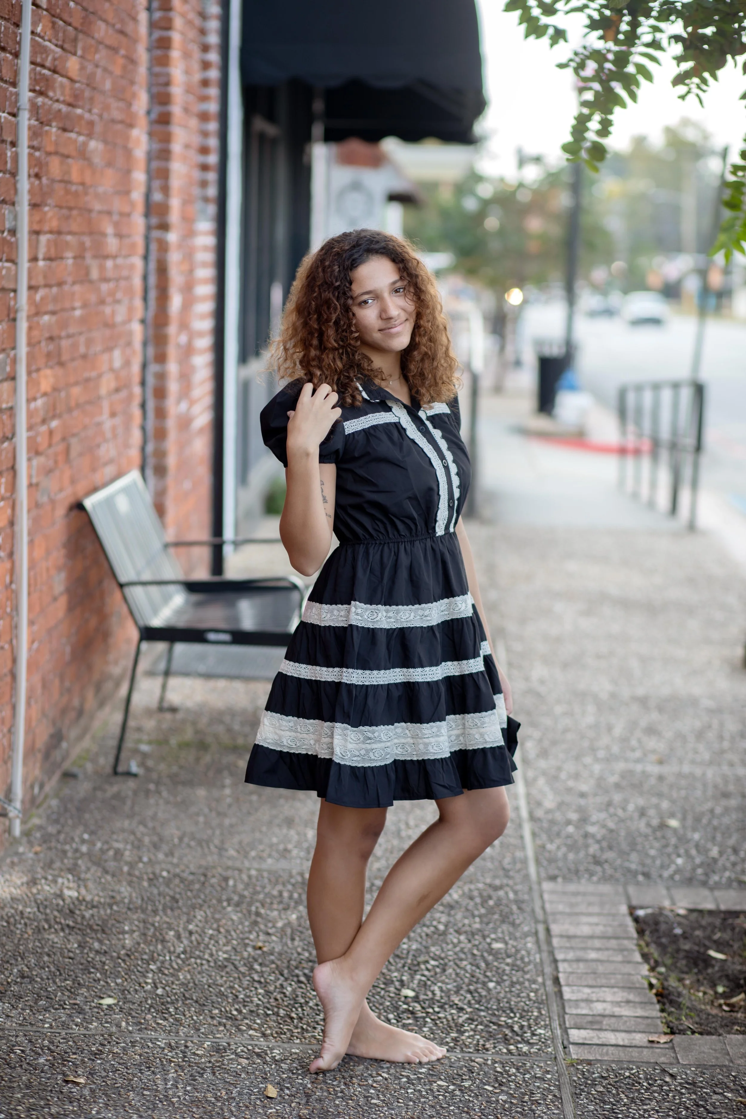 A mini dress featuring puff sleeves, a high neckline with scalloped lace trim, and a button-down front placket