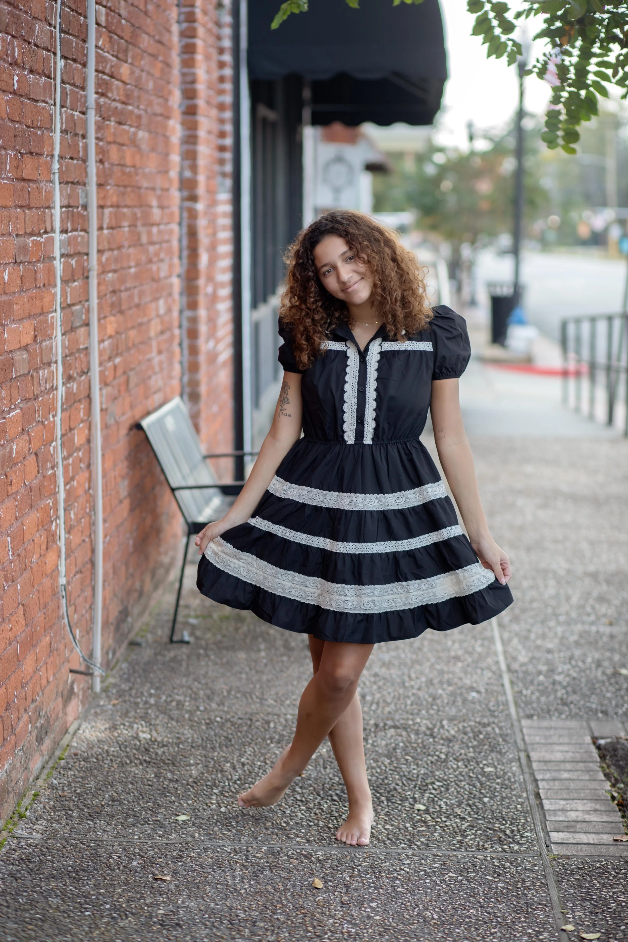 A mini dress featuring puff sleeves, a high neckline with scalloped lace trim, and a button-down front placket