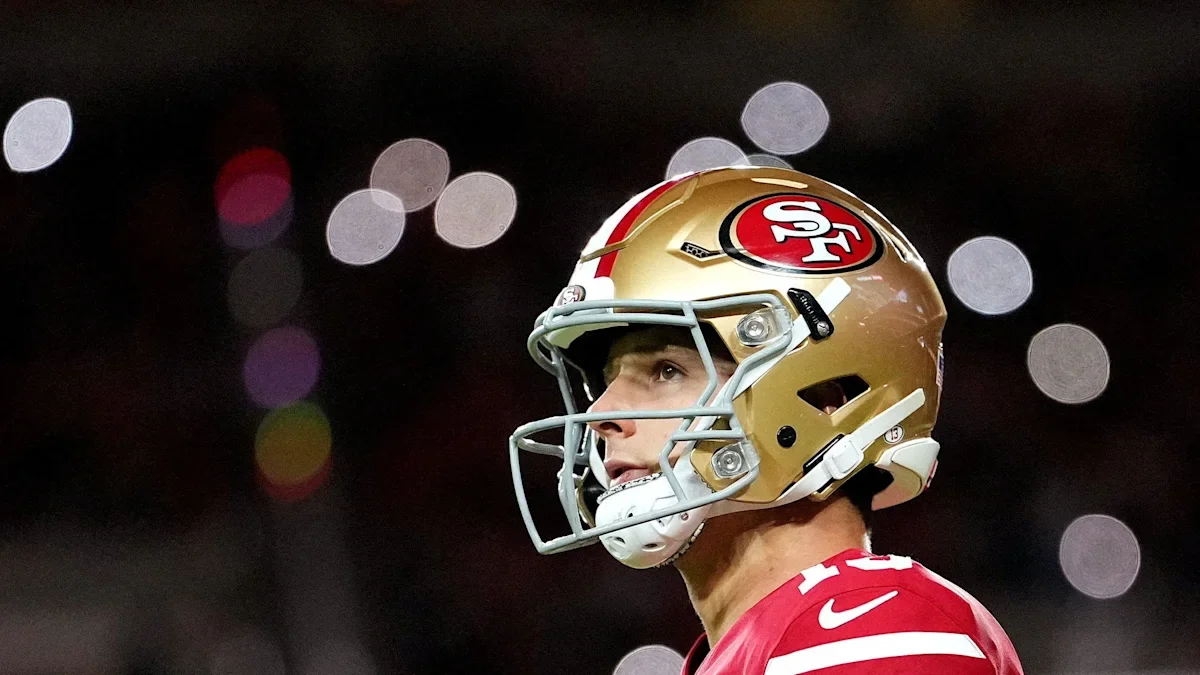 49ers QB Brock Purdy staring into the lights at night game