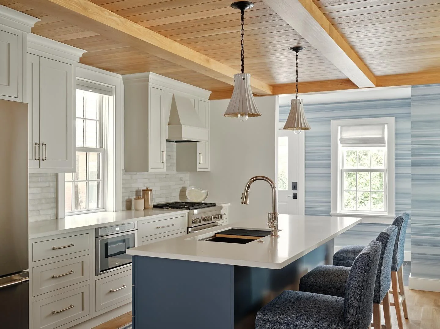 I&rsquo;m not a shiny kind of gal. If there is a lot of shiny in a kitchen, I layer in texture to balance it all. I didn&rsquo;t design this kitchen. The builder did a great job in a tight space. 
I brought texture and cohesiveness to a compact but o
