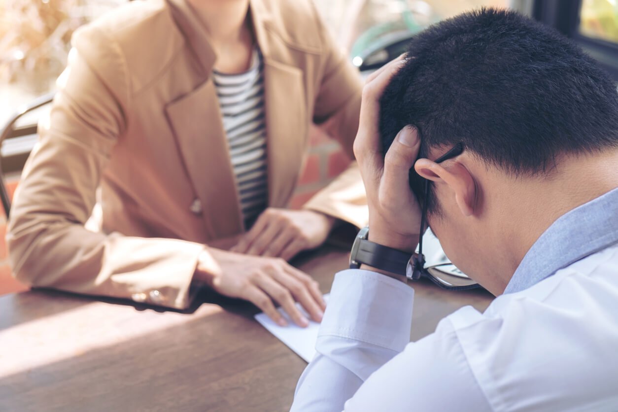 Distressed client discussing domestic assault charges during a legal consultation