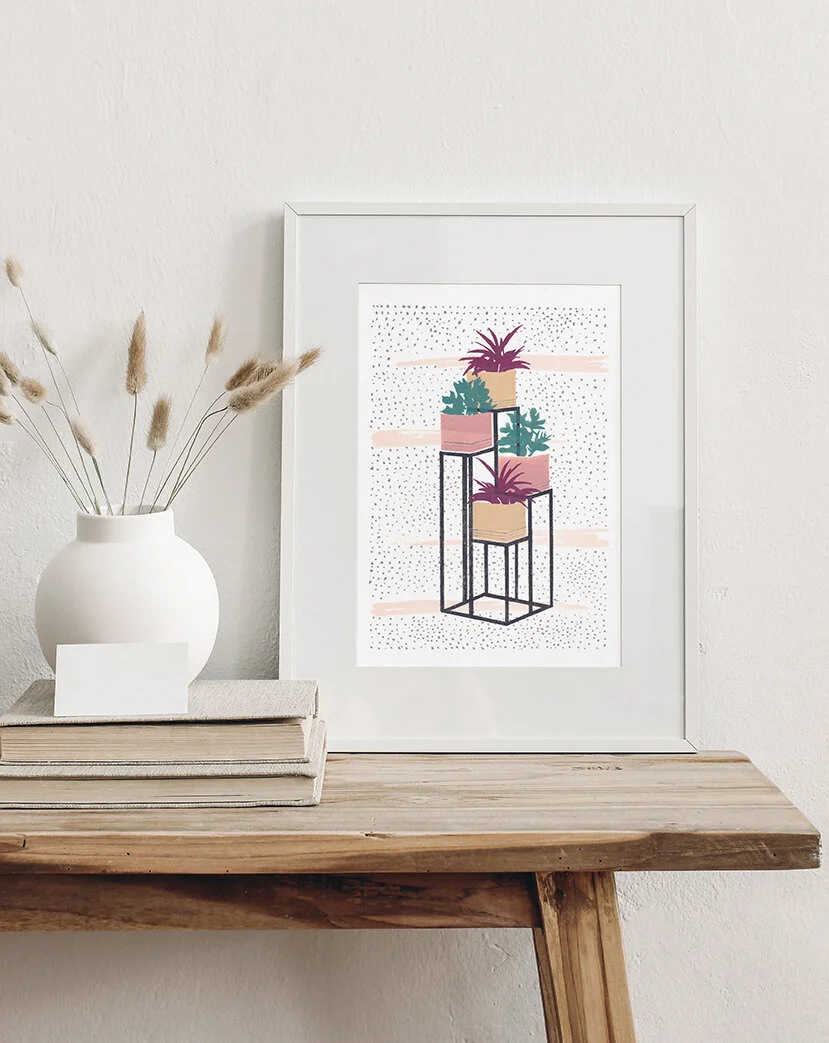 botanical artwork in a frame near plants