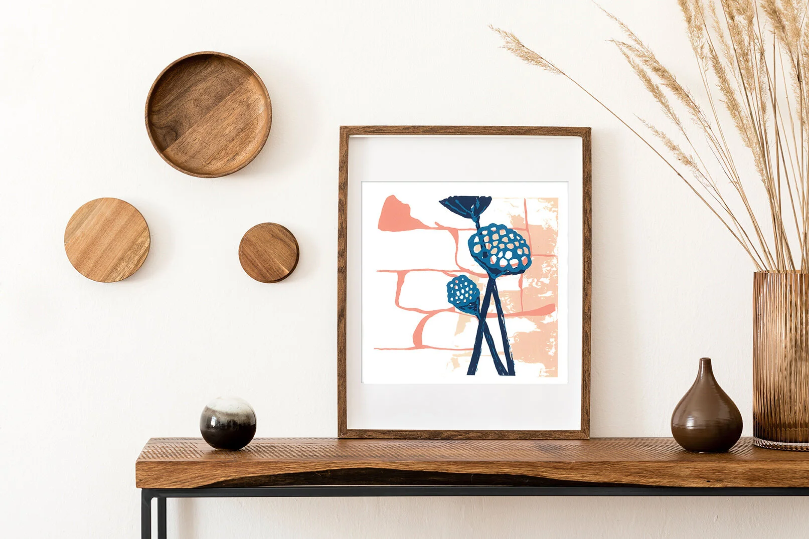a frame hangs, containing 'Lotus Pods' artwork
