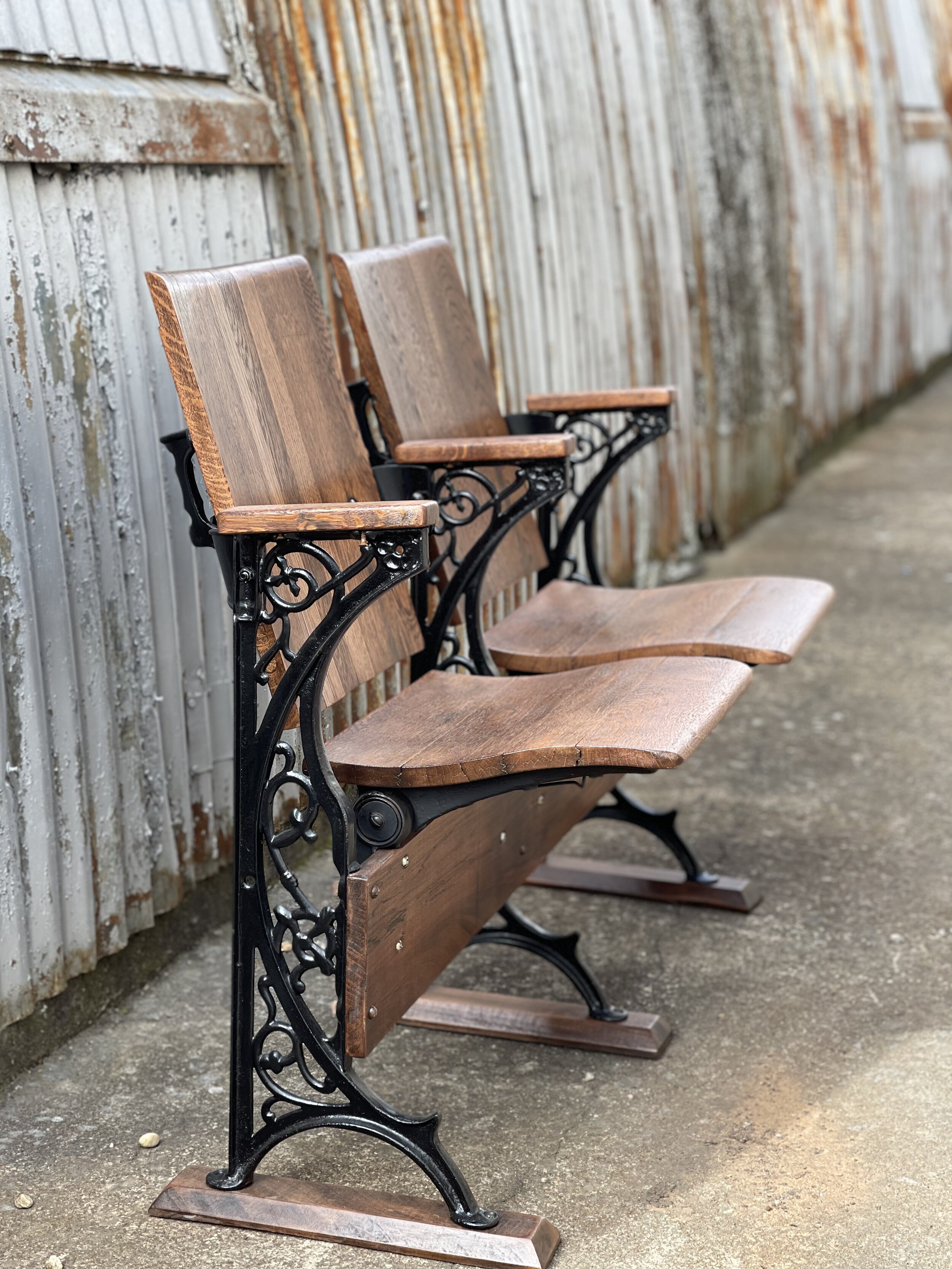 Jerry found this pair of vintage folding chairs beside a dumpster. The wood was gray and weathered. The metal was rusted. He took them into his shop and took every piece apart. He sanded and refinished the wood, cleaned up the metal and painted i