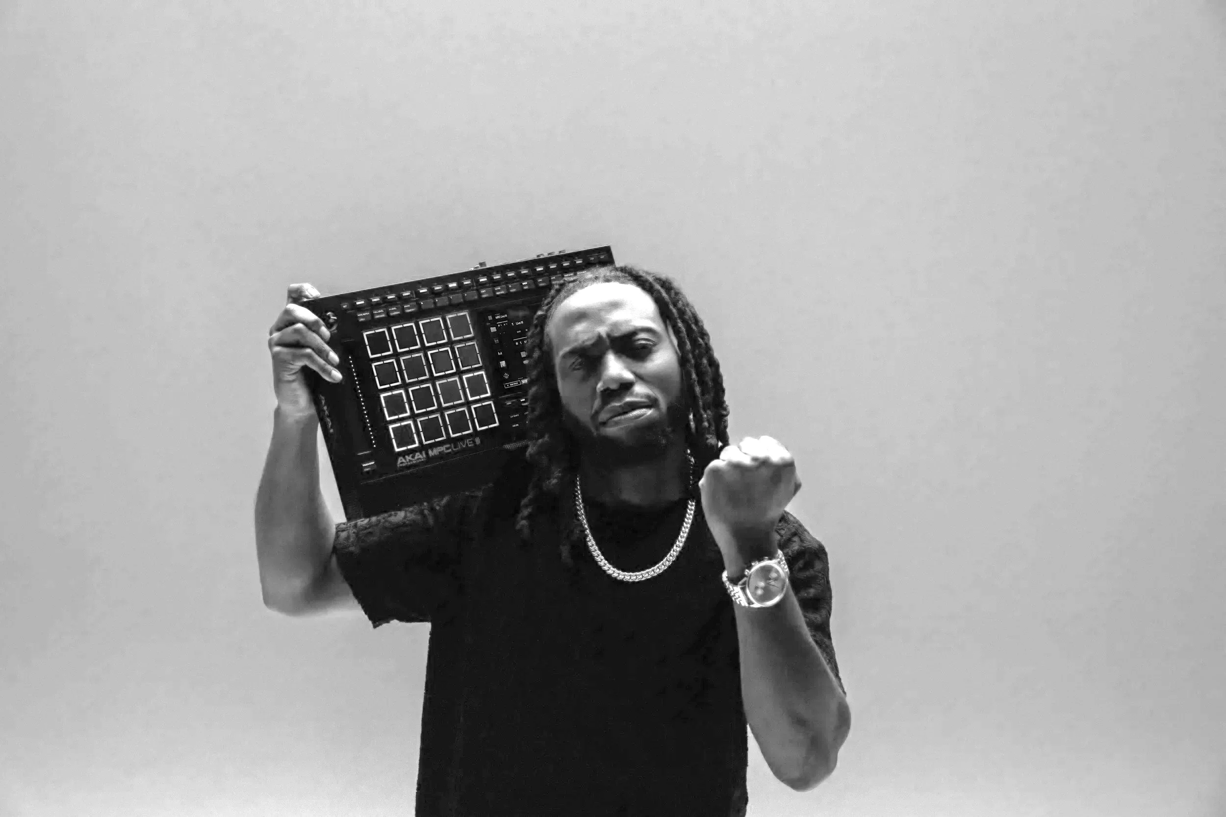 Jay holding the MPC on his shoulder, fist up