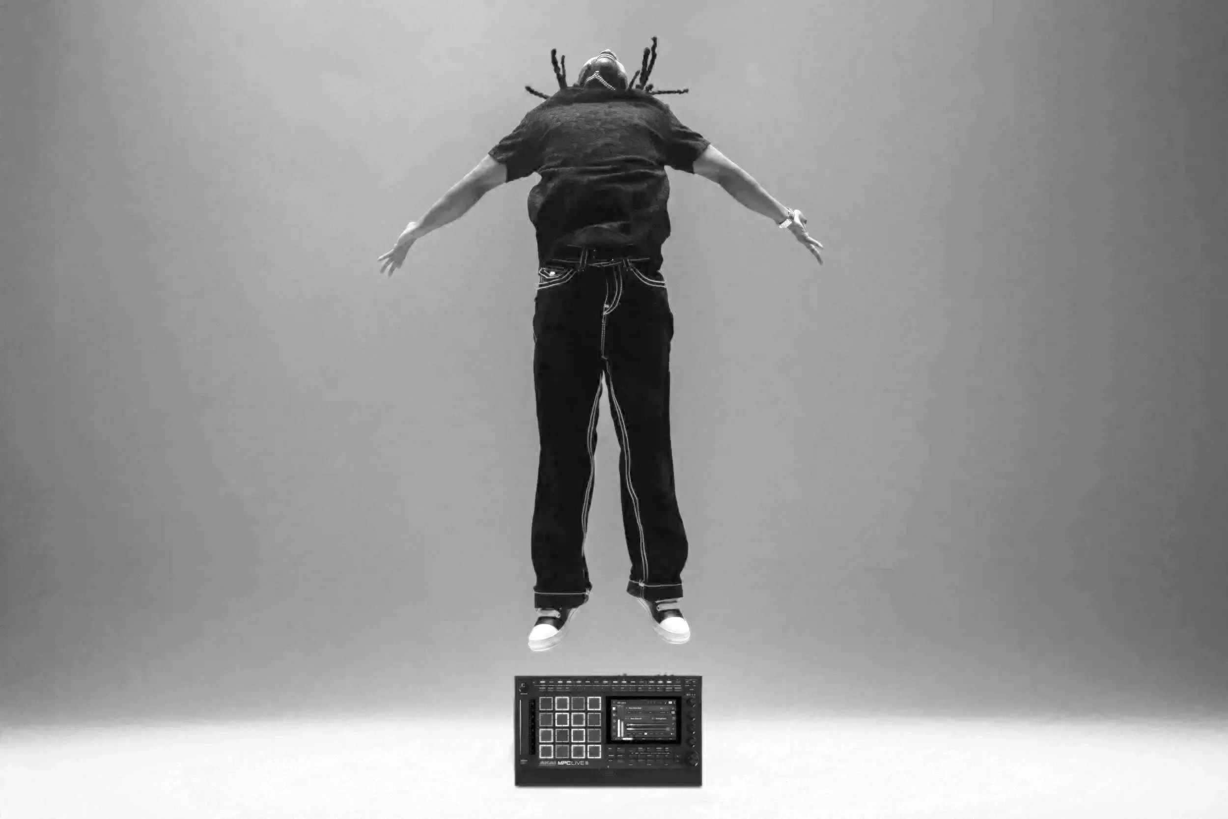 Jay levitating above an MPC, arms out