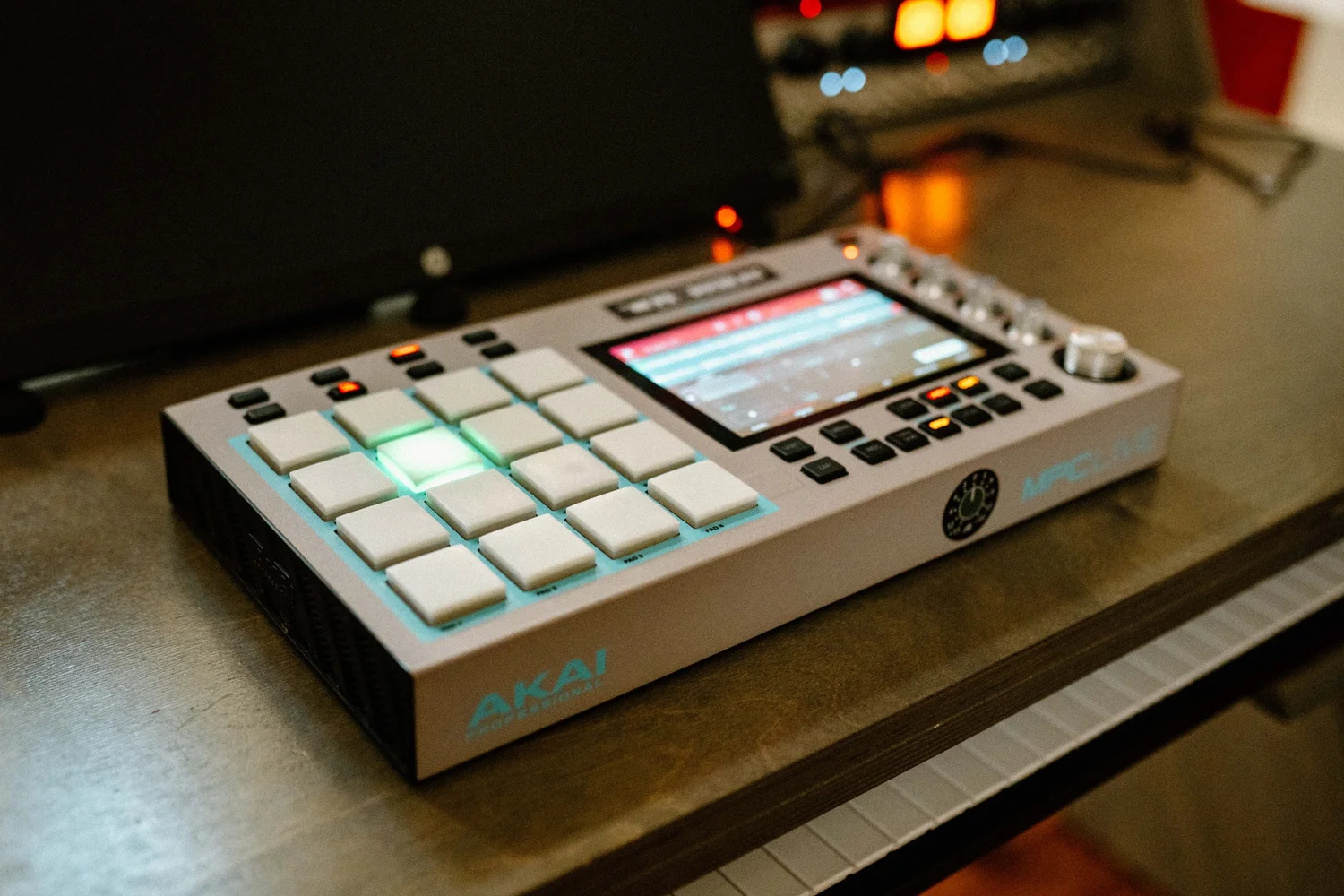 Jay's MPC Live II on the desk, pads lit green