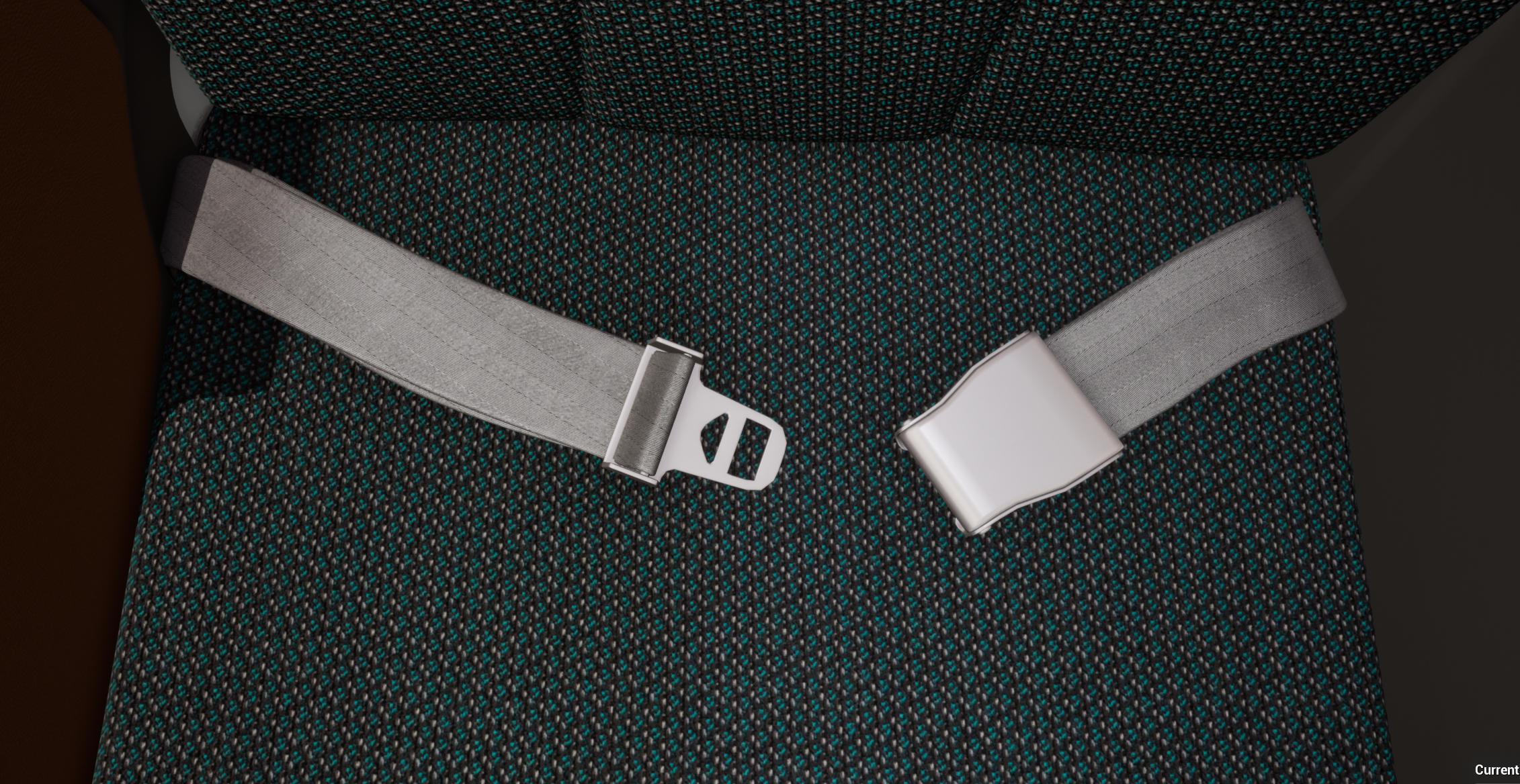 Close-up of a 3-point seatbelt with a silver buckle on a dark, textured fabric seat.