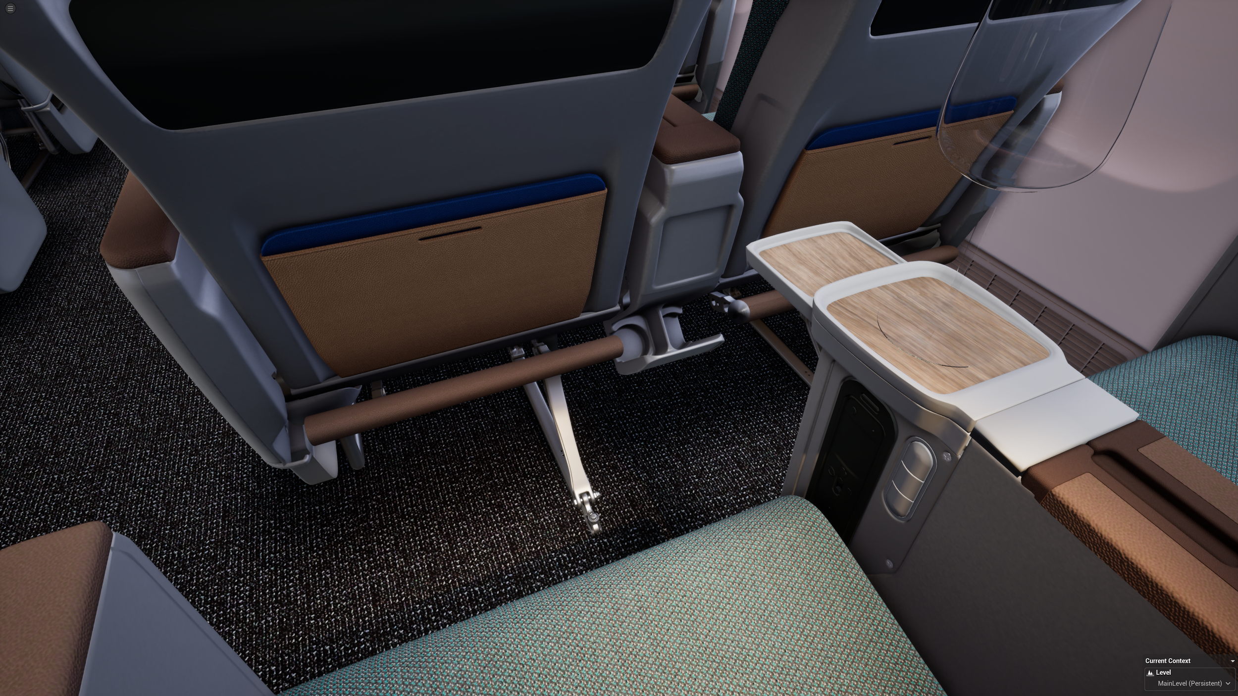 Interior of an airplane cabin showing seats, tray tables, footrests, and carpeting.