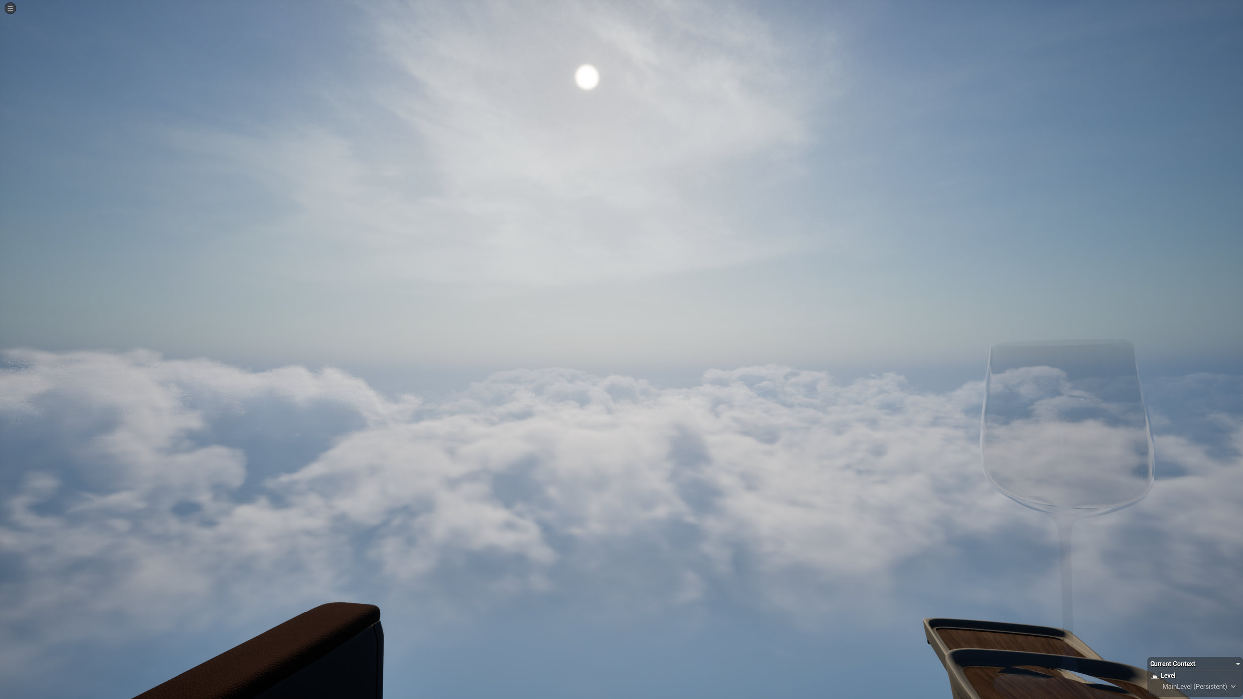 View of the sky from an airplane with clouds below, the sun shining, and a clear glass of wine on a tray table.