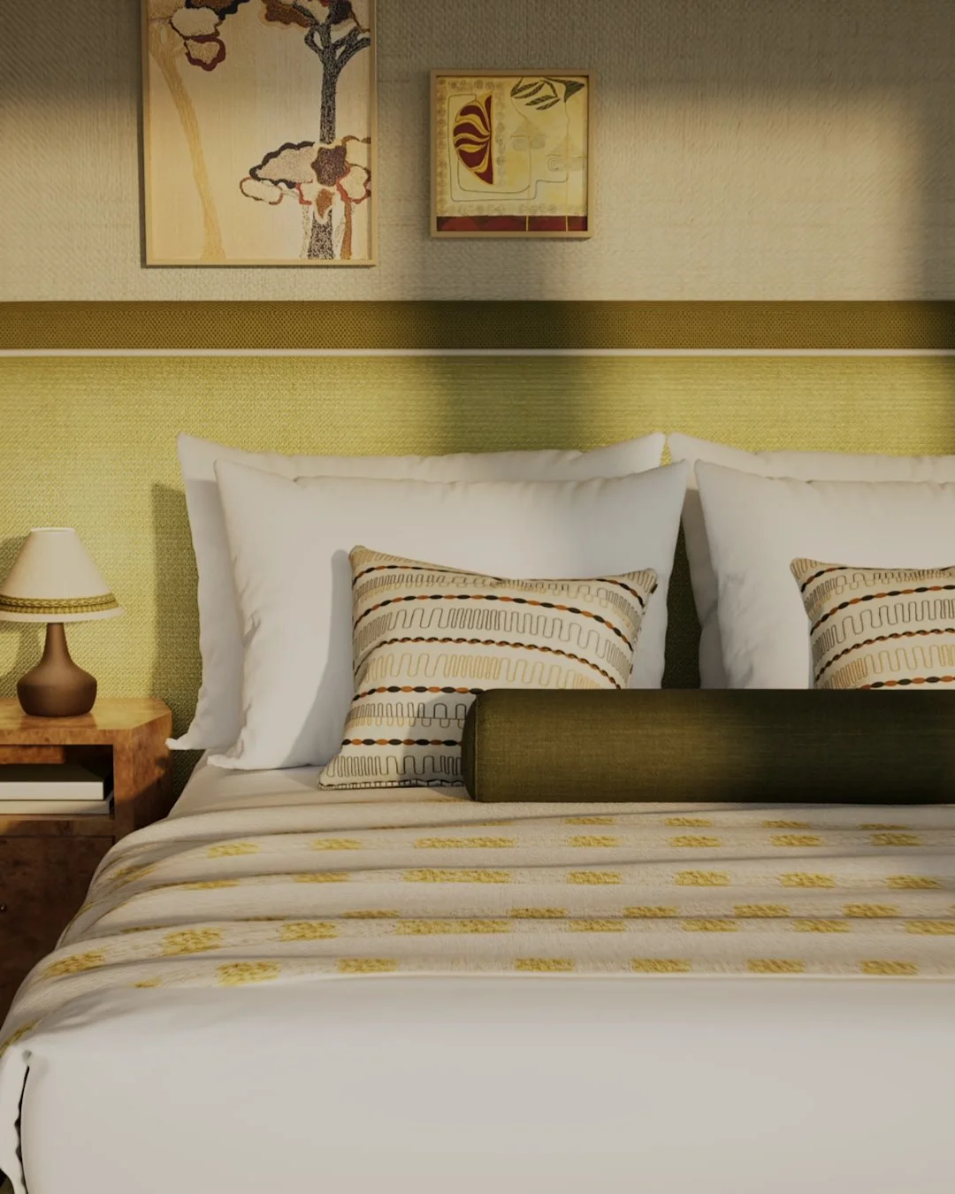 A neatly made bed with white pillows and patterned pillows, a bed runner, a wooden nightstand with a lamp, and artwork hanging above headboard in a hotel room.