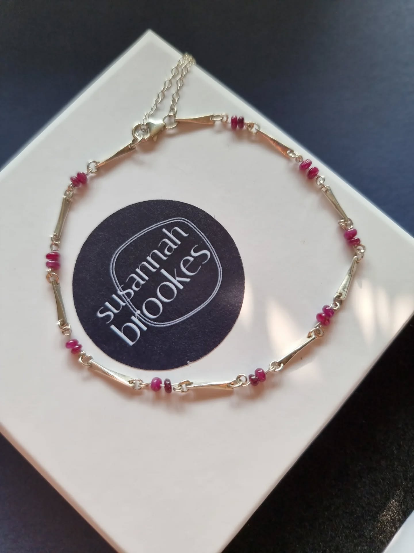 💕 Such a special gift 💕

I absolutely loved designing and making this very special anniversary gift. 

A gorgeously delicate silver bracelet sparkling with tiny rubies to mark 40 years together.  Each little rectangular link is cut and hammered to 