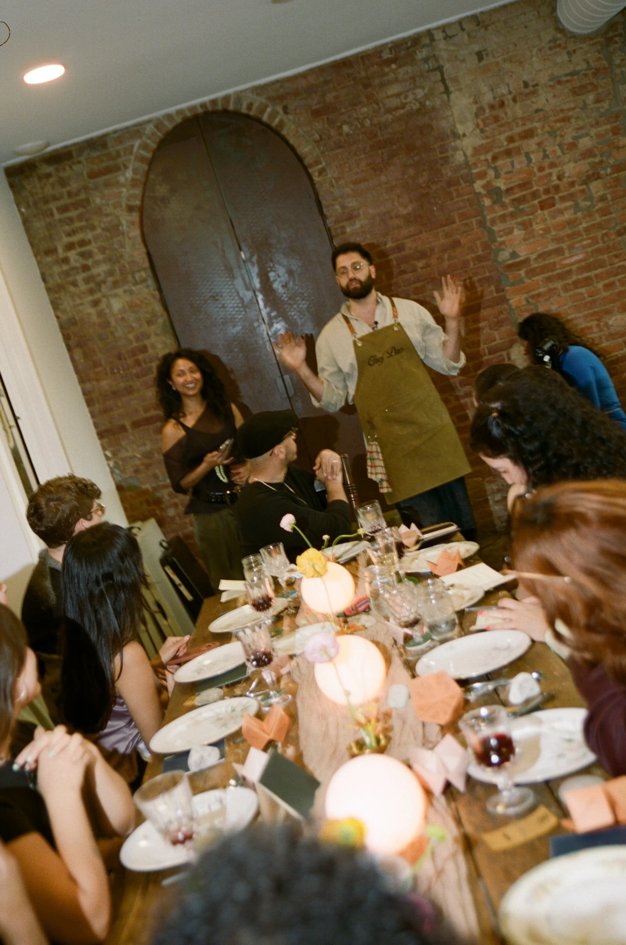 Chef Pedro addressing guests at FCK006, an intimate dinner and listening session designed by Held Here at Rosa Night Flower in Williamsburg, Brooklyn — experiential design and community strategy by Mai Nguyen