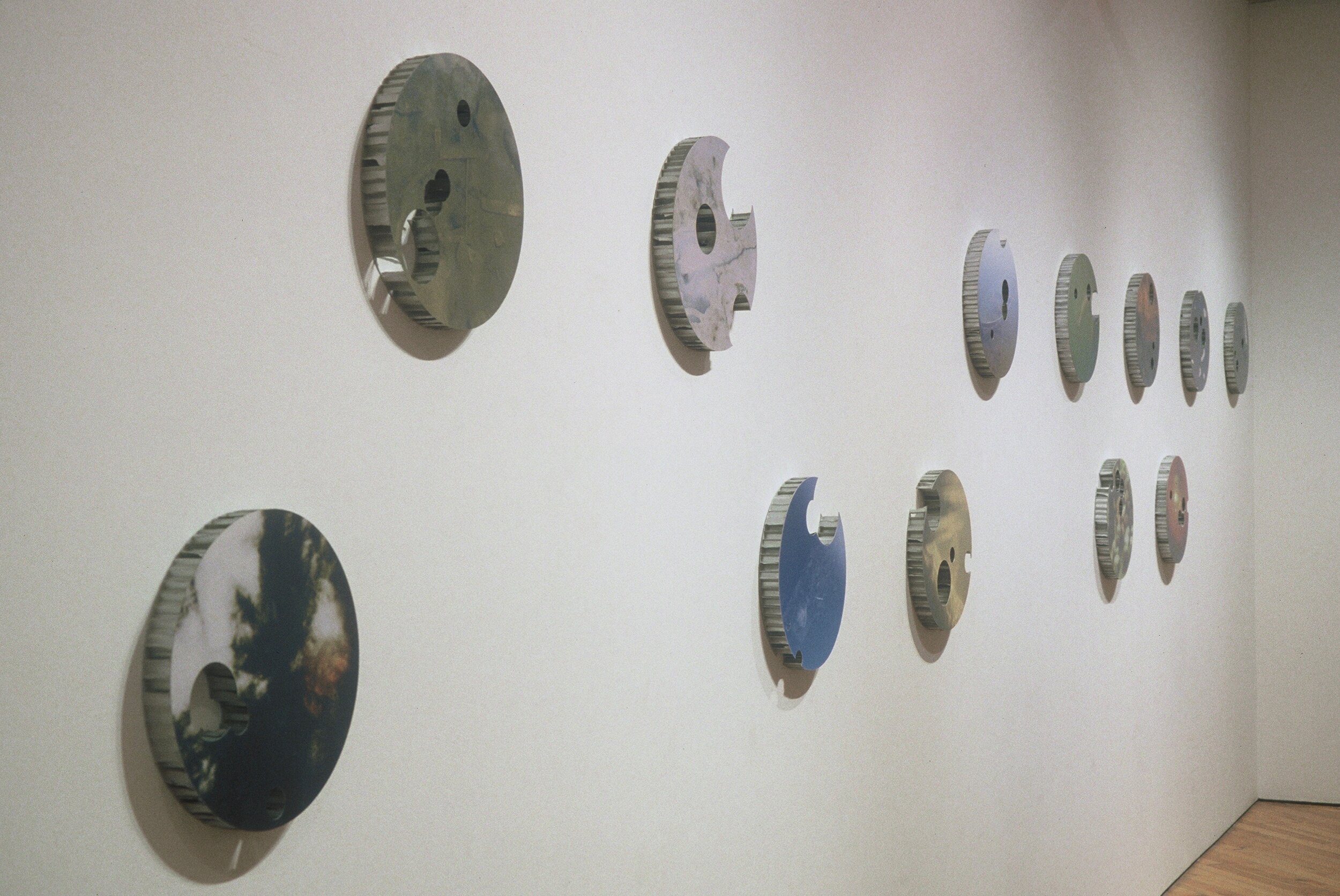 Surface Film.
12 colour prints on cut-out honeycomb aluminum discs. each 2": 15" dia