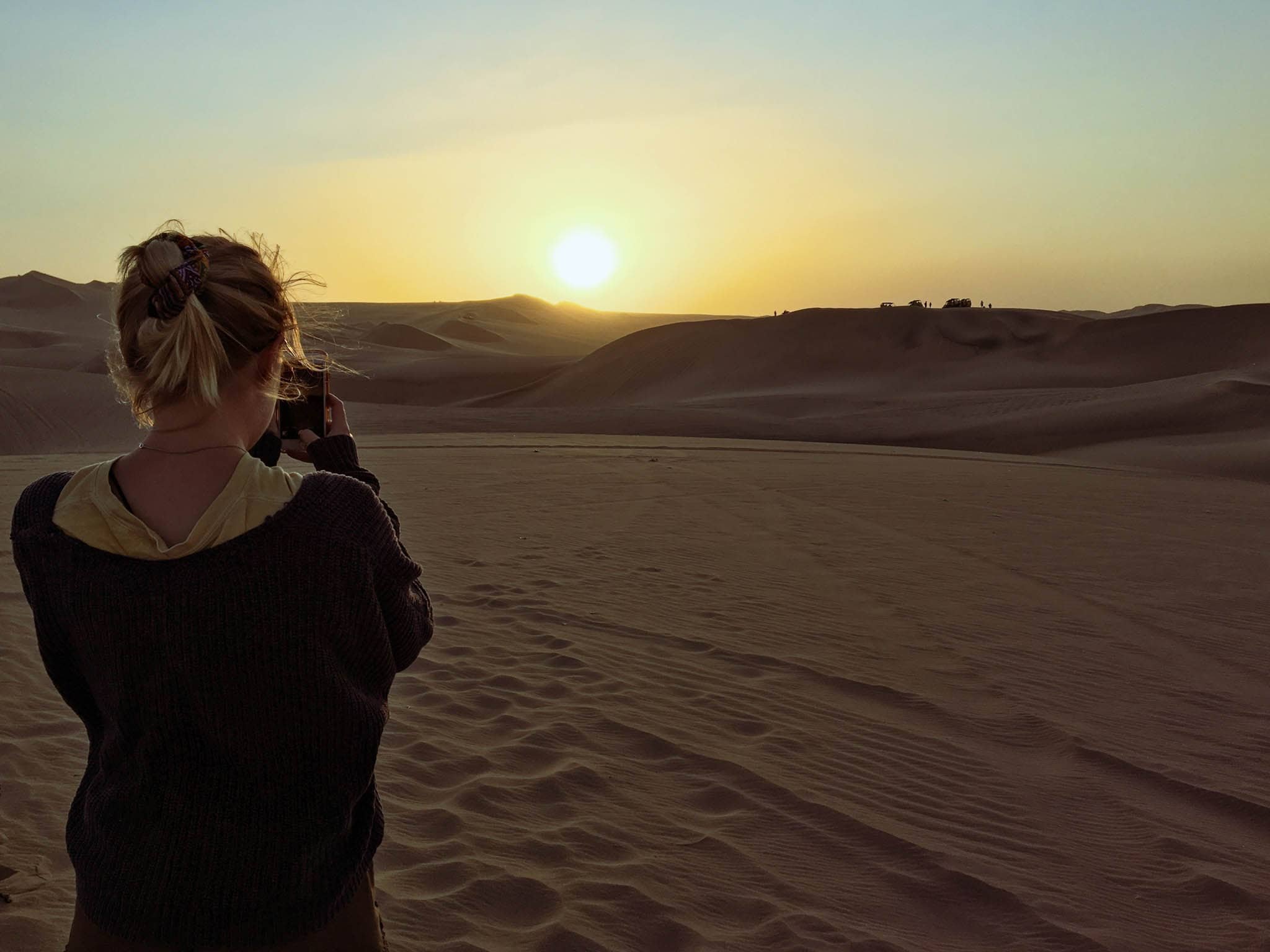 Sun setting over the sand dunes in Huacachina - Peru