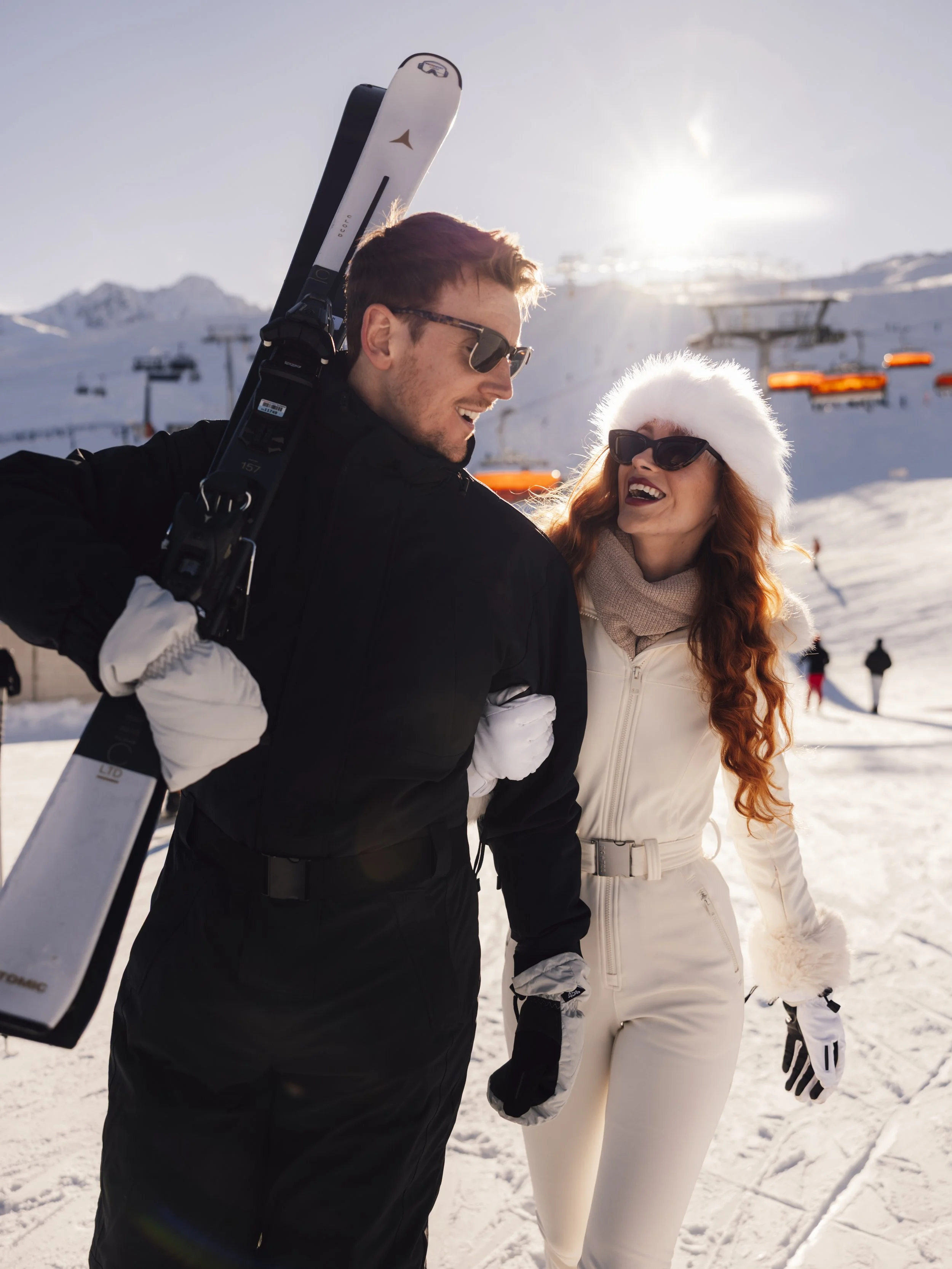Couple walking together in ski gear during a winter destination elopement in the Austrian Alps