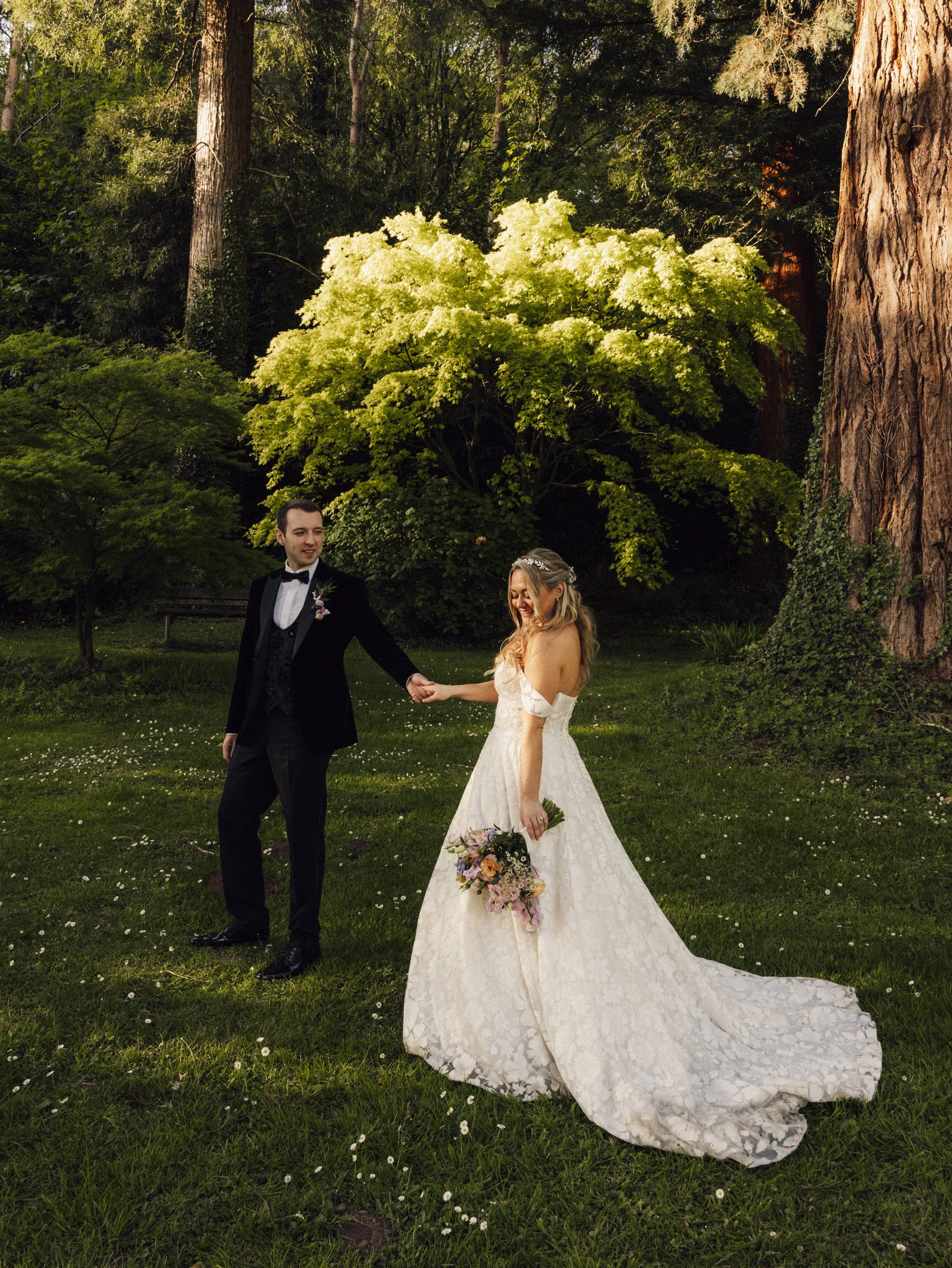 A bride and groom hand in hand at their gorgeous wedding venue New house country hotel in cardiff.