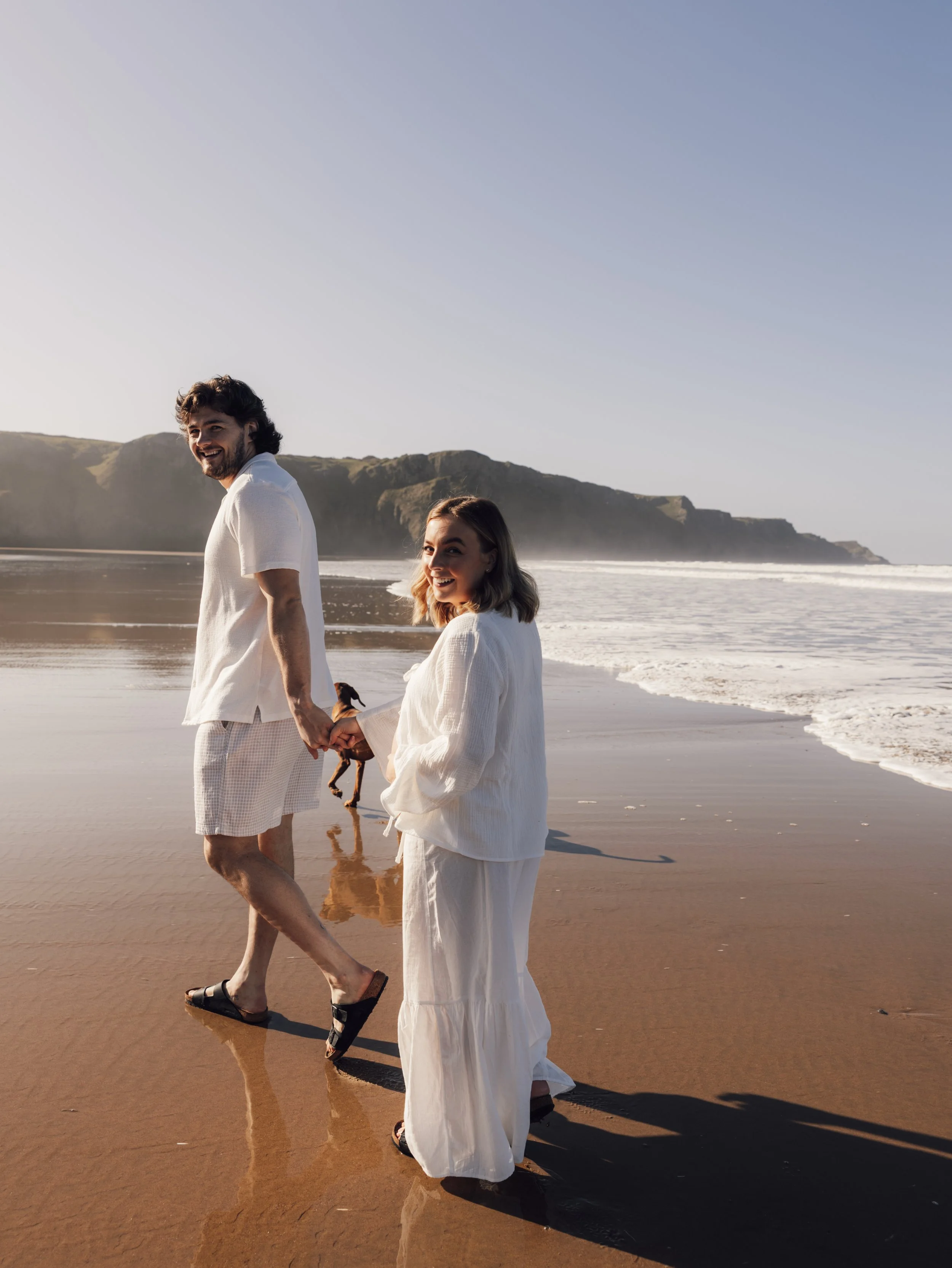 Natural maternity photography capturing movement on a coastal path