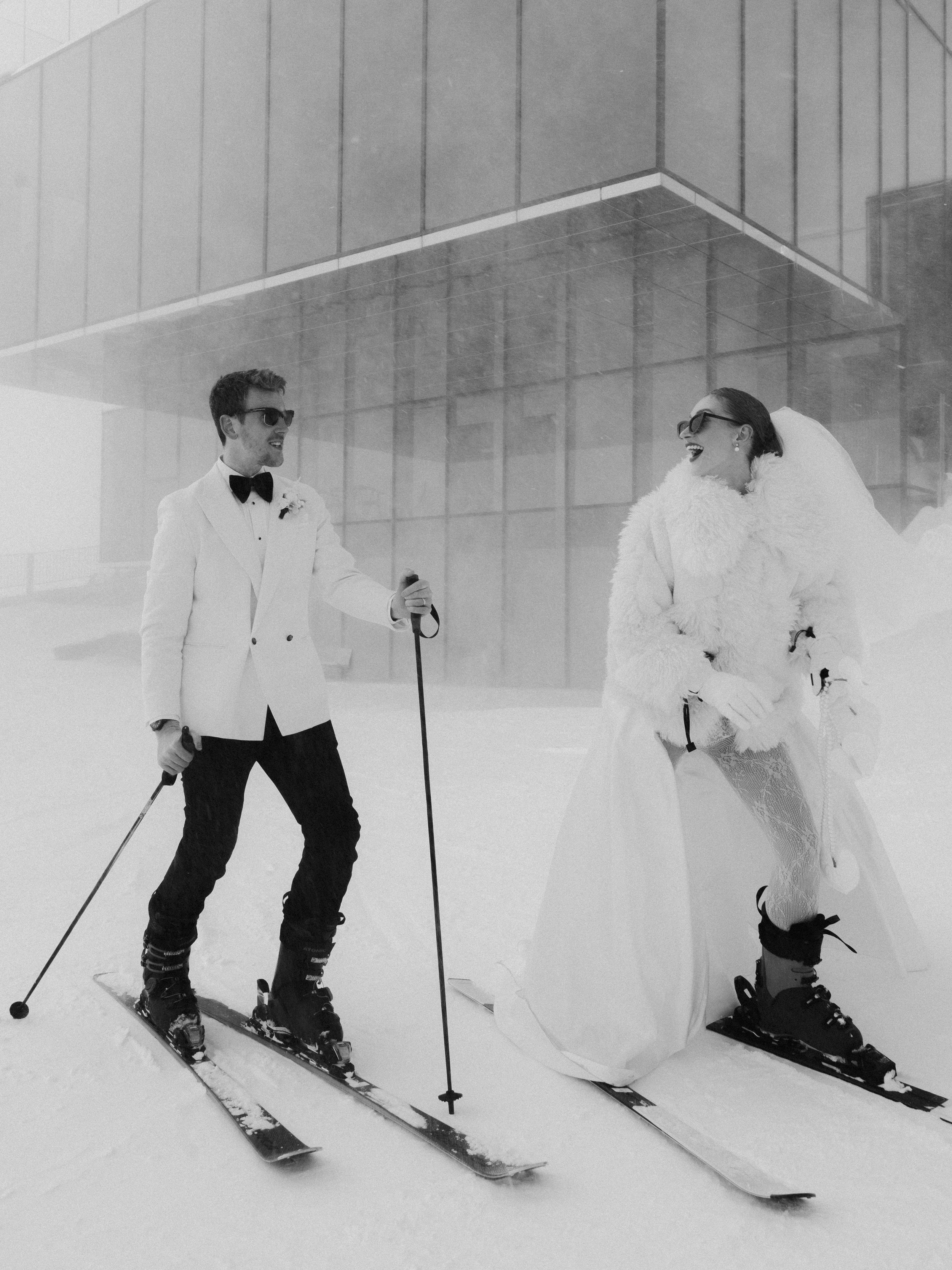 Bride and groom skiing together during a winter elopement in the Austrian Alps