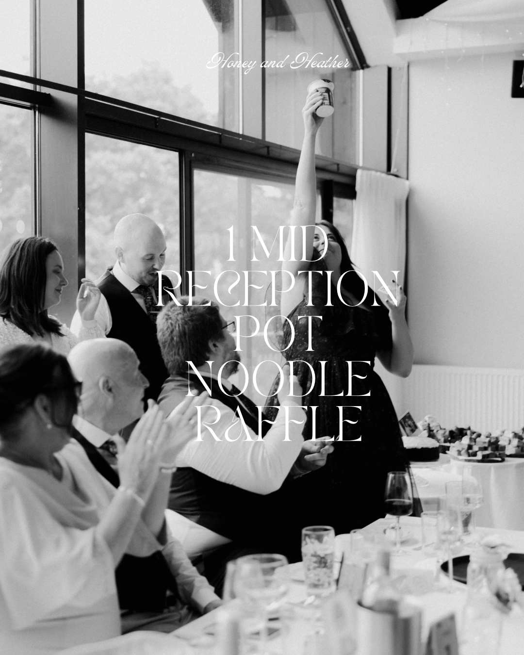 Black and white photo of wedding guests cheering and laughing during a fun reception game, with one guest holding up a pot noodle as a prize, with text overlay.