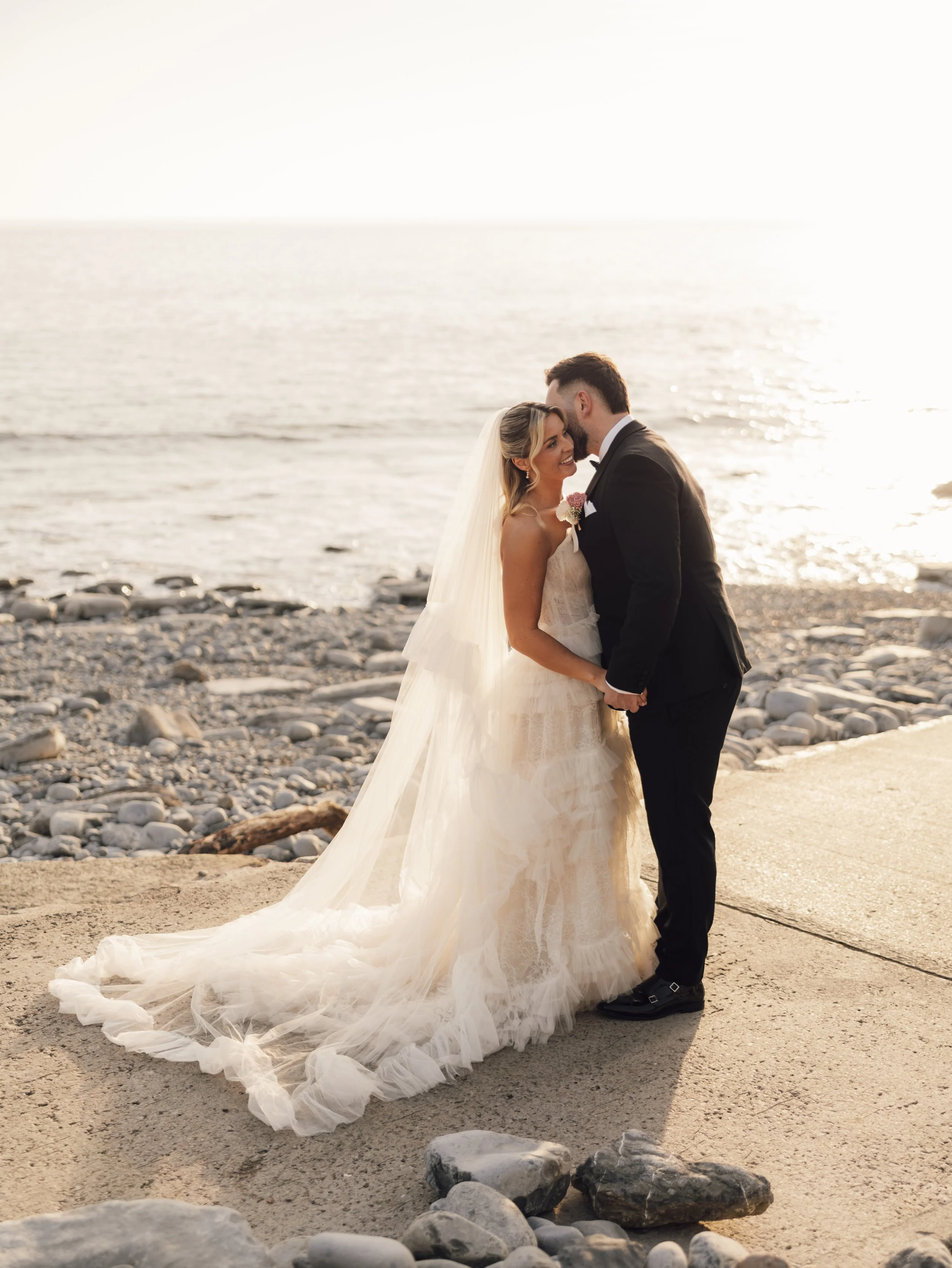 A portrait of a newly married couple at sunset at Southerndown