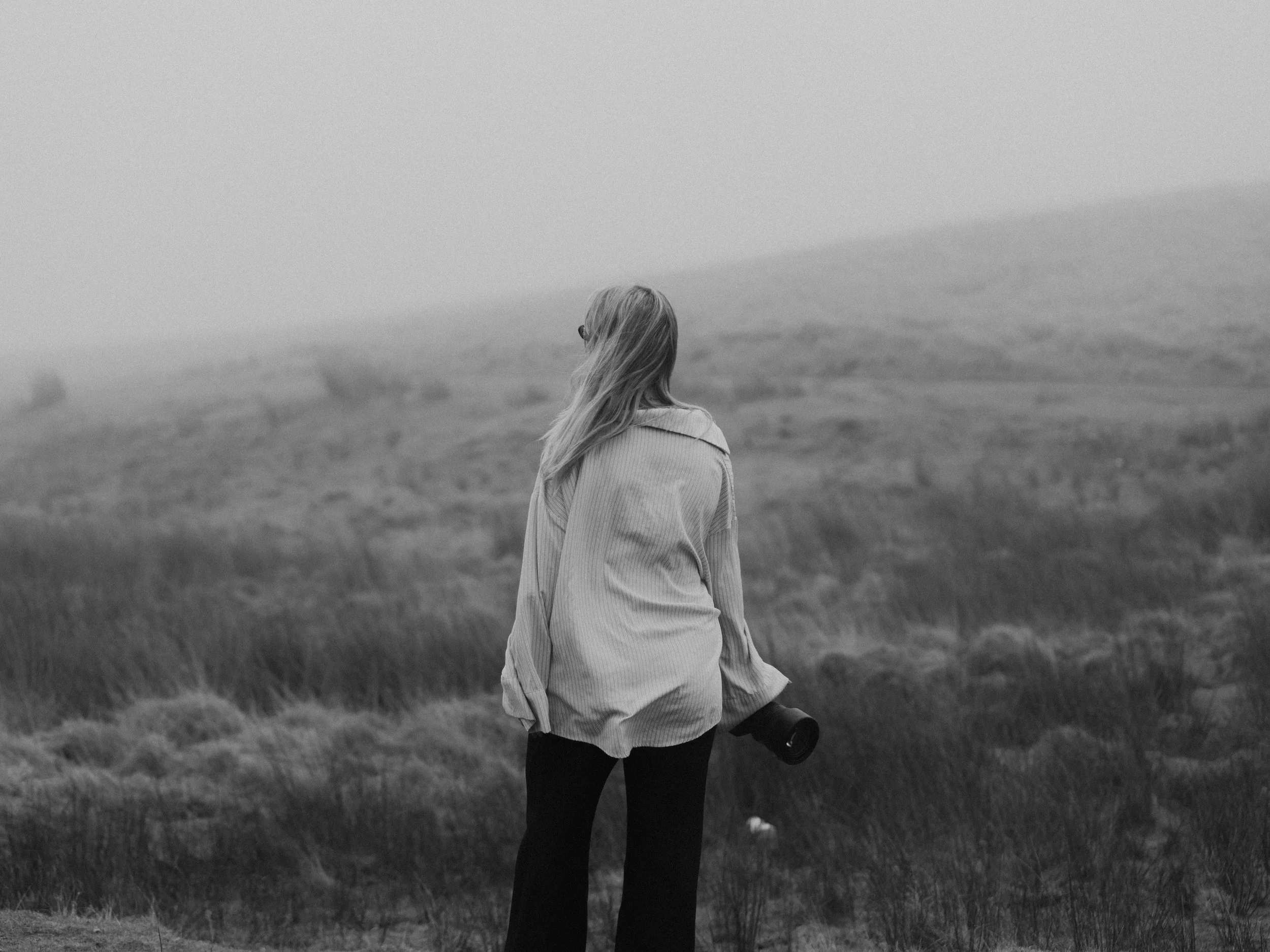 Black and white branding portrait of a wedding photographer in South Wales, photographed outdoors in Brecon.