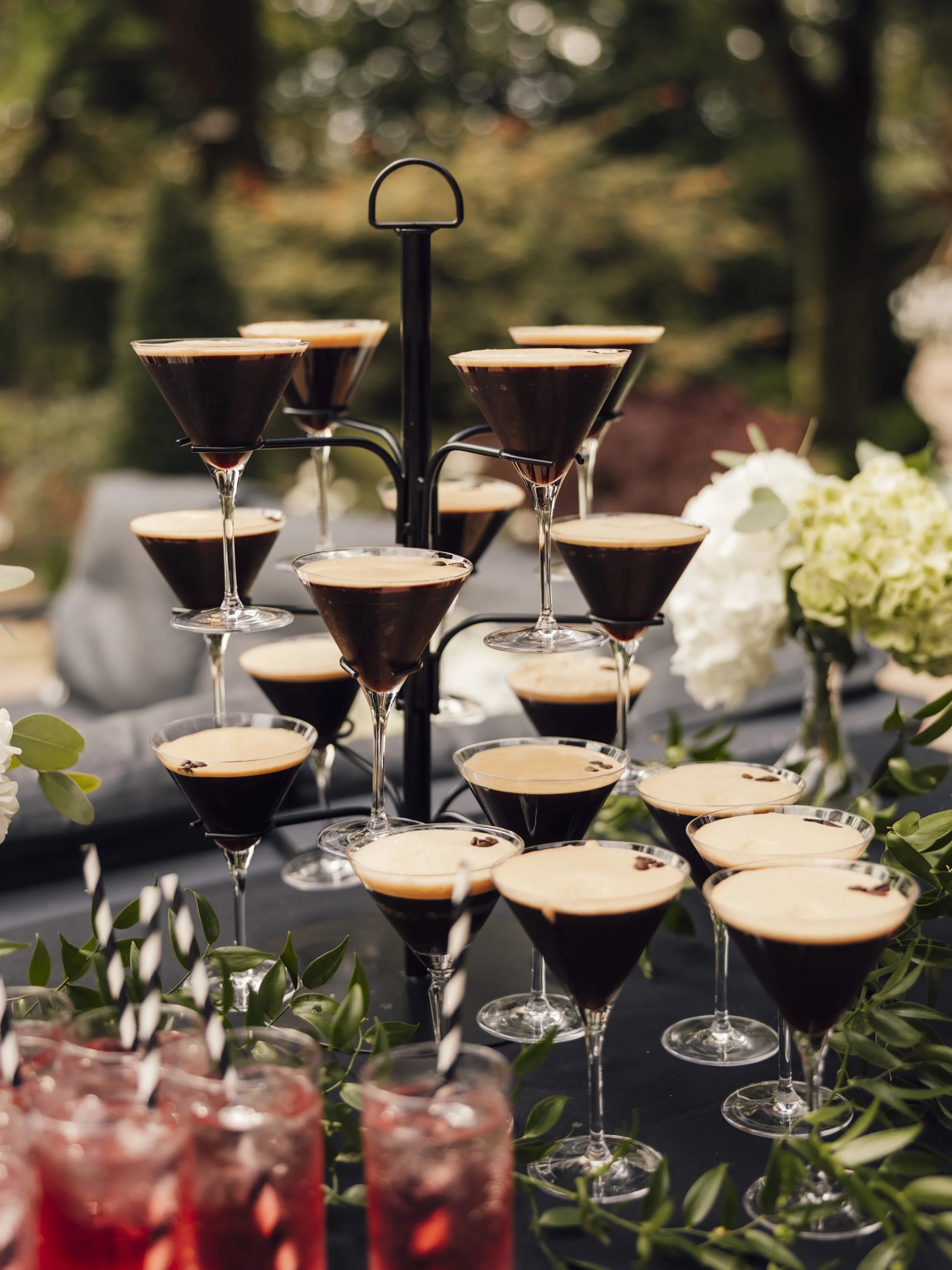 Espresso martini cocktail tower set up for a relaxed outdoor wedding reception
