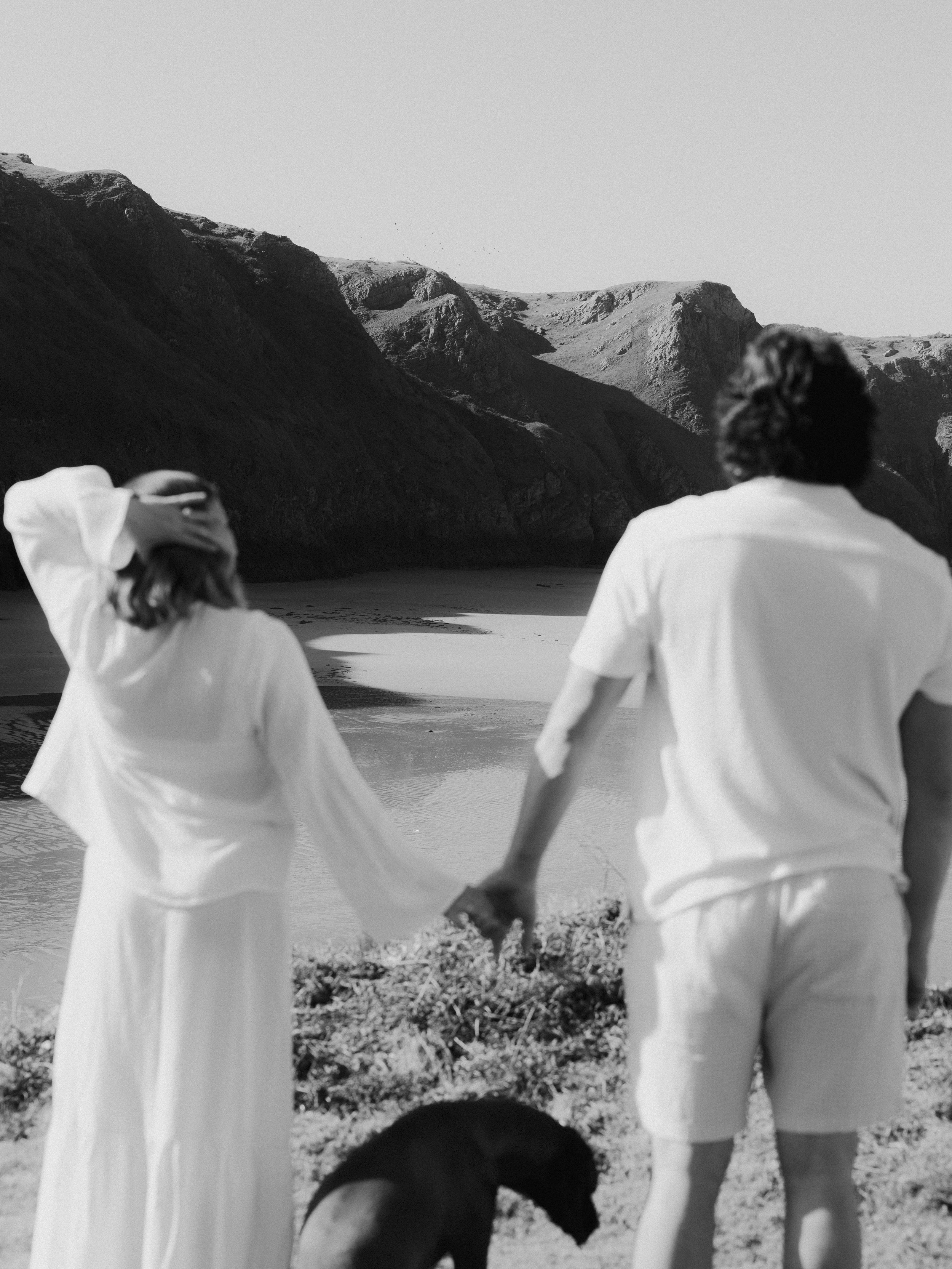 Sunset maternity photos on a South Wales beach with soft golden light