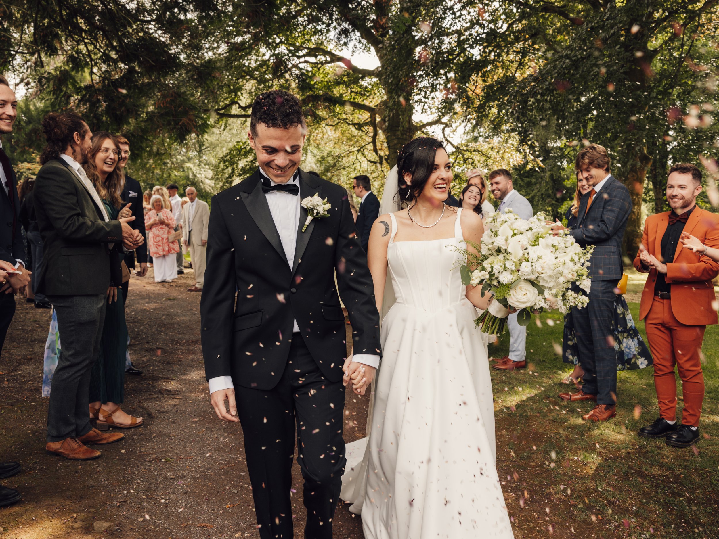 Couple walking together after their ceremony during a relaxed, outdoor wedding celebration