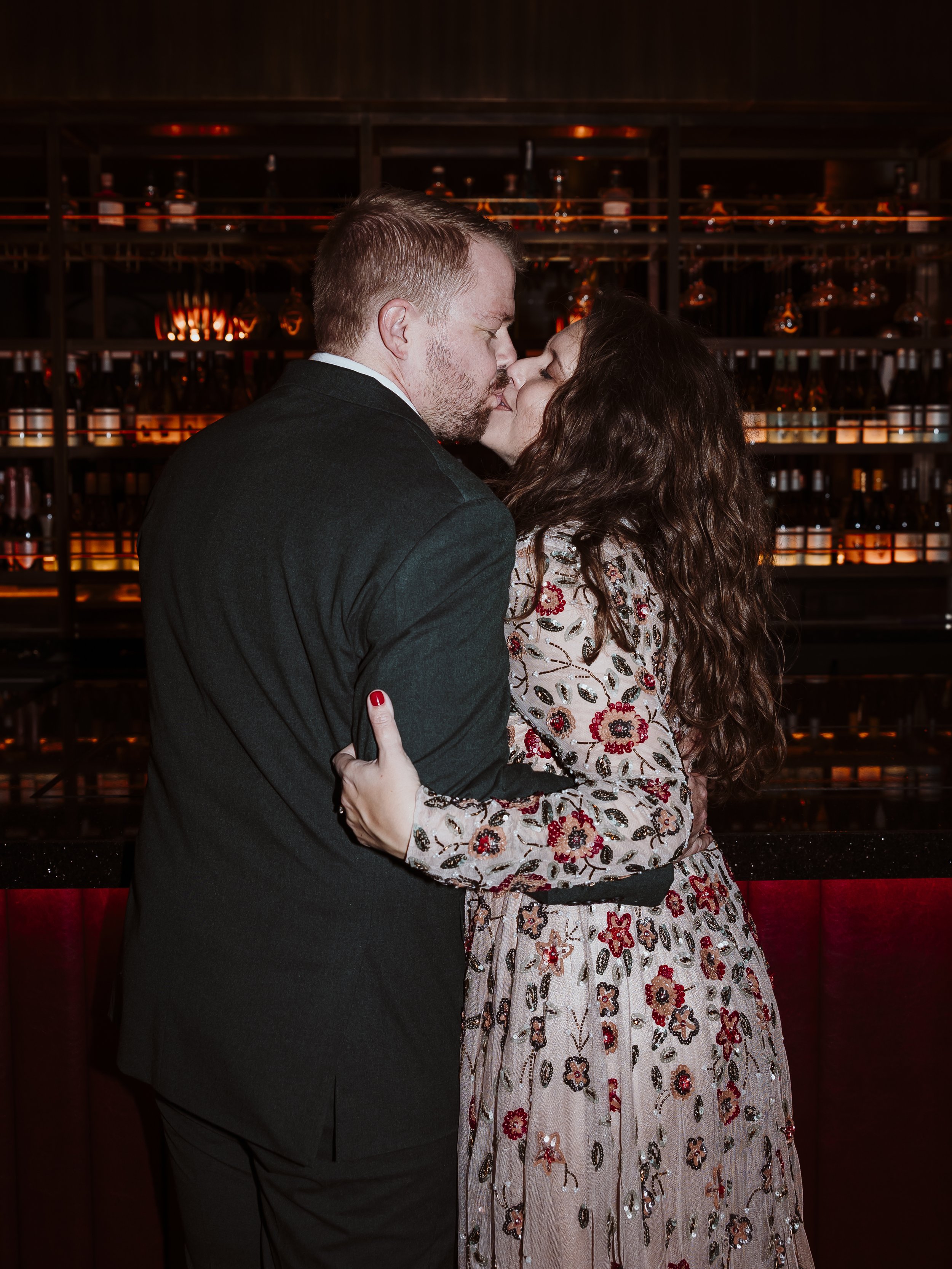 Bride and groom kissing in a luxury bar at The Other House hotel in South Kensington after their London elopement.