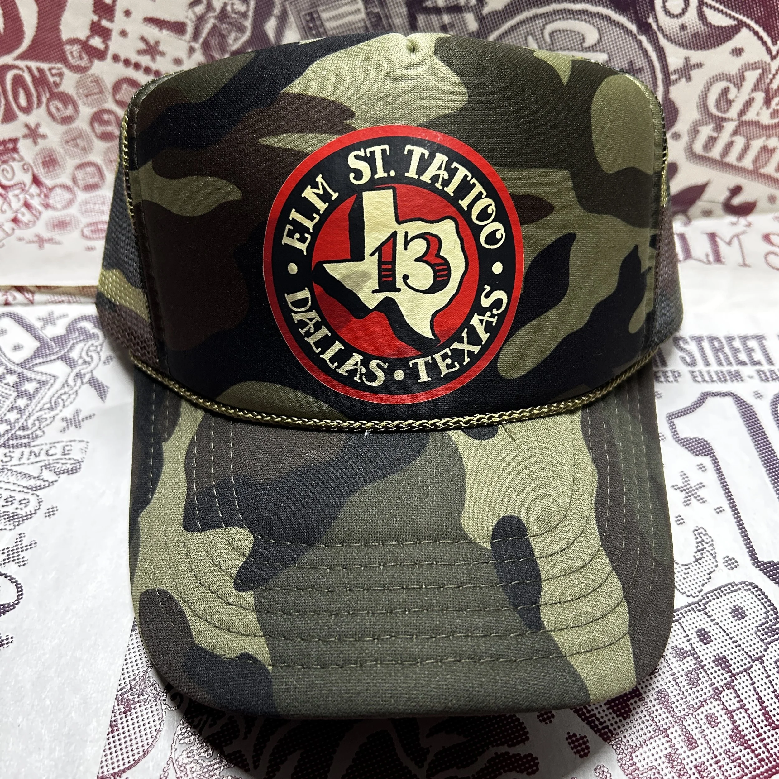 Elm Street Tattoo Texas 13 Logo Graphic Printed Camo Trucker Hat