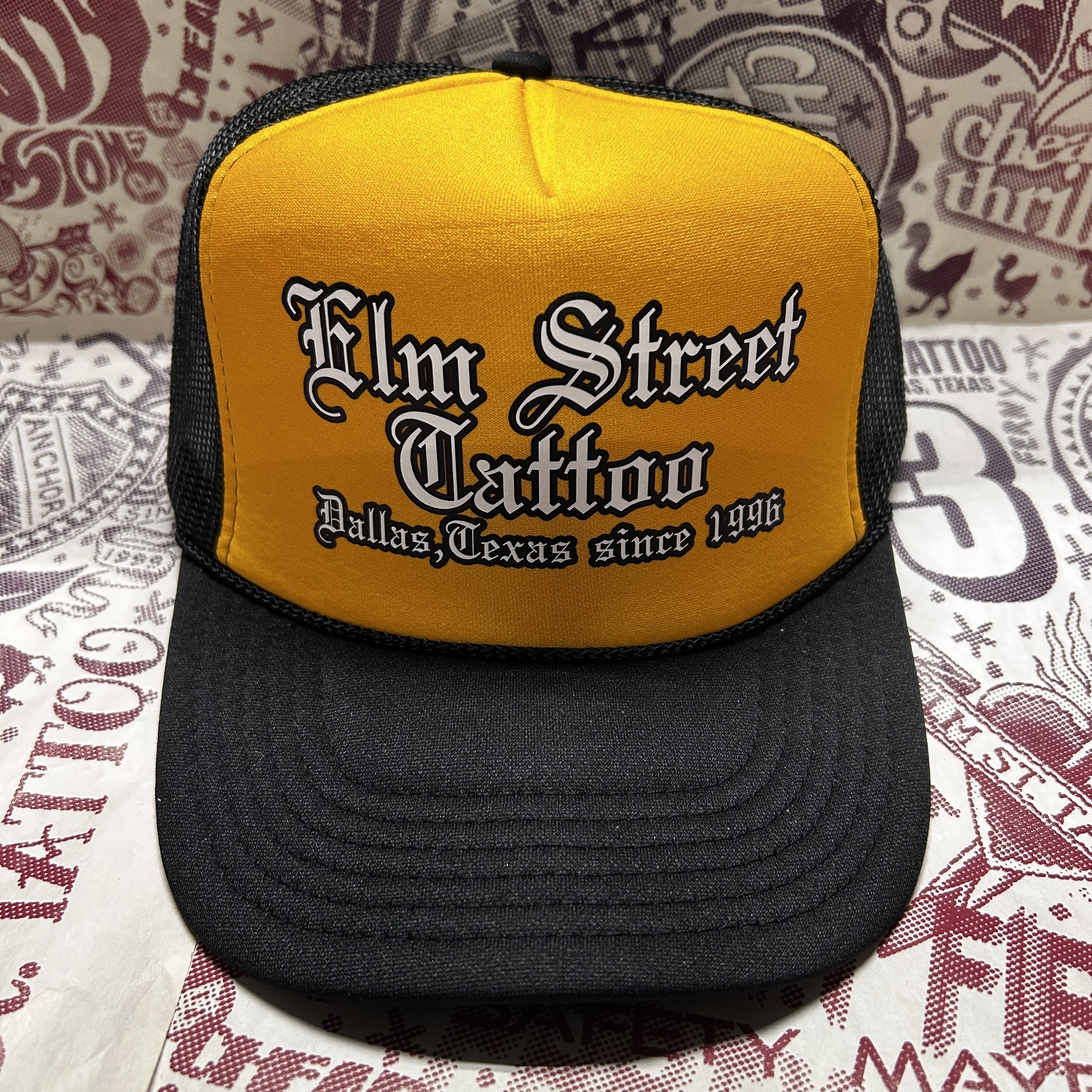 Elm Street Tattoo Old English Logo Graphic Printed Trucker Hat (Colors: Black/Gold | Black/White)