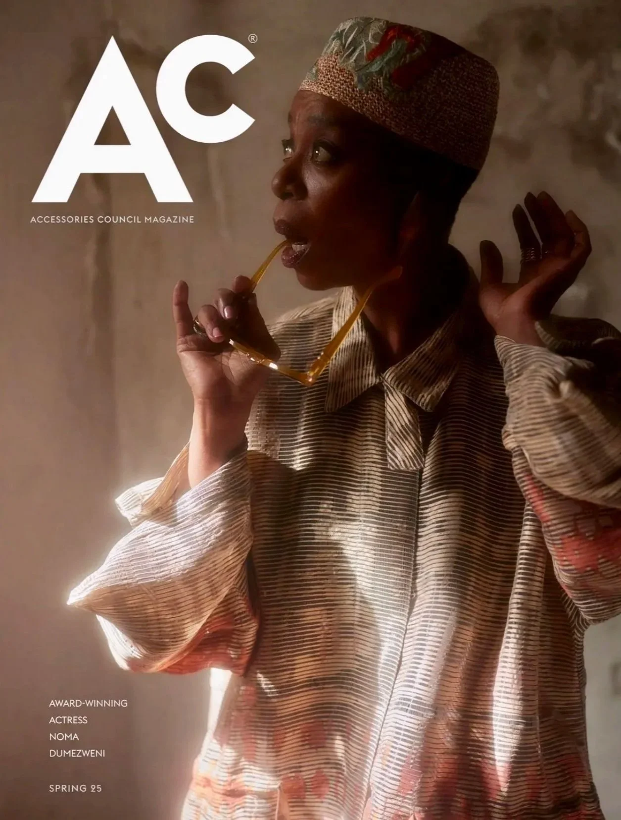 Cover of Accessories Council Magazine featuring a woman wearing a colorful headwrap and striped shirt, holding sunglasses near her face, with the title 'AC' and text indicating awards and actress Noma Dumezweni for Spring 25.