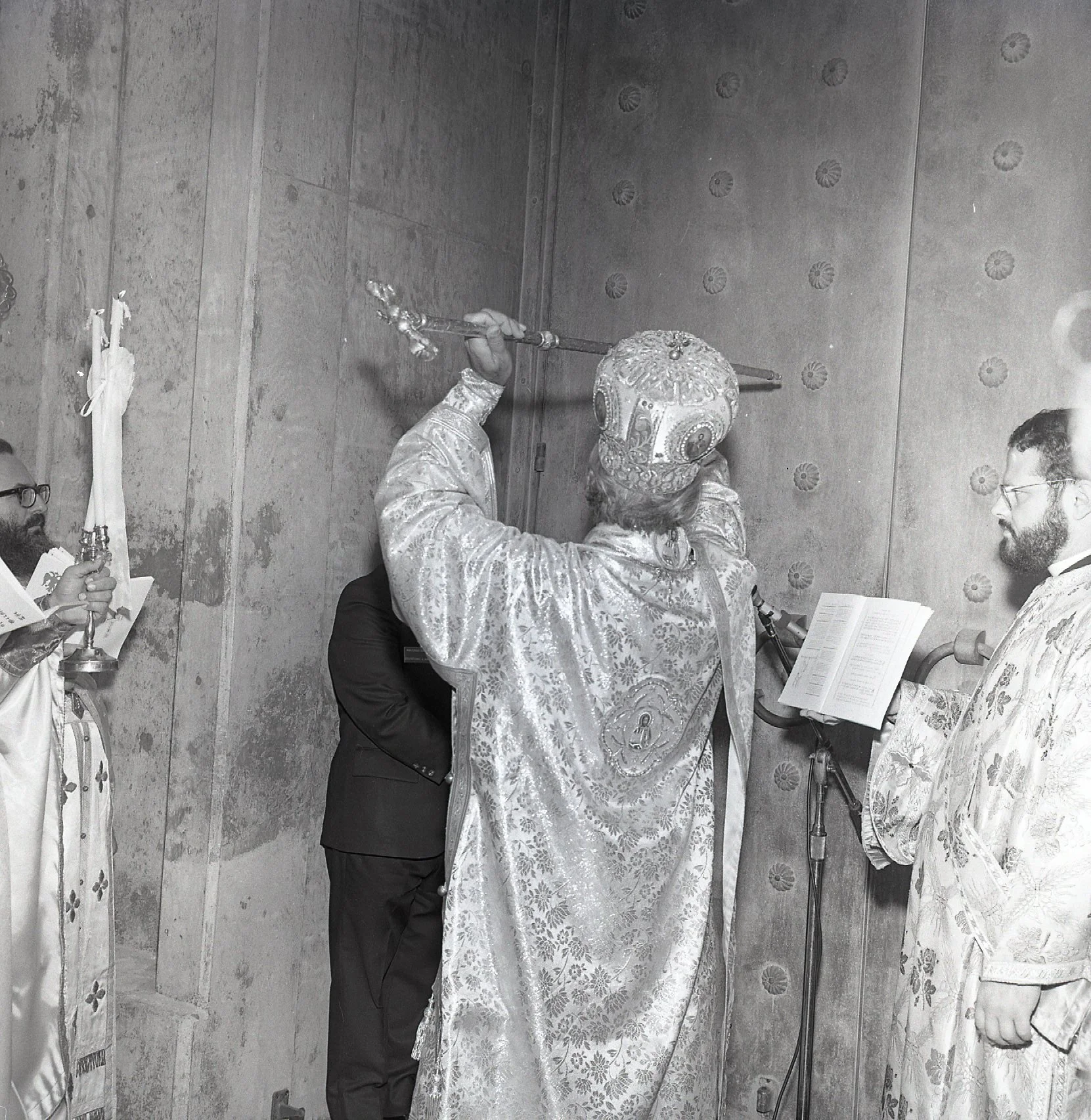 Archbishop Iakovos knocks on the church door with his staff. "Open the gates and let them remain open forever and let the King of Glory enter."