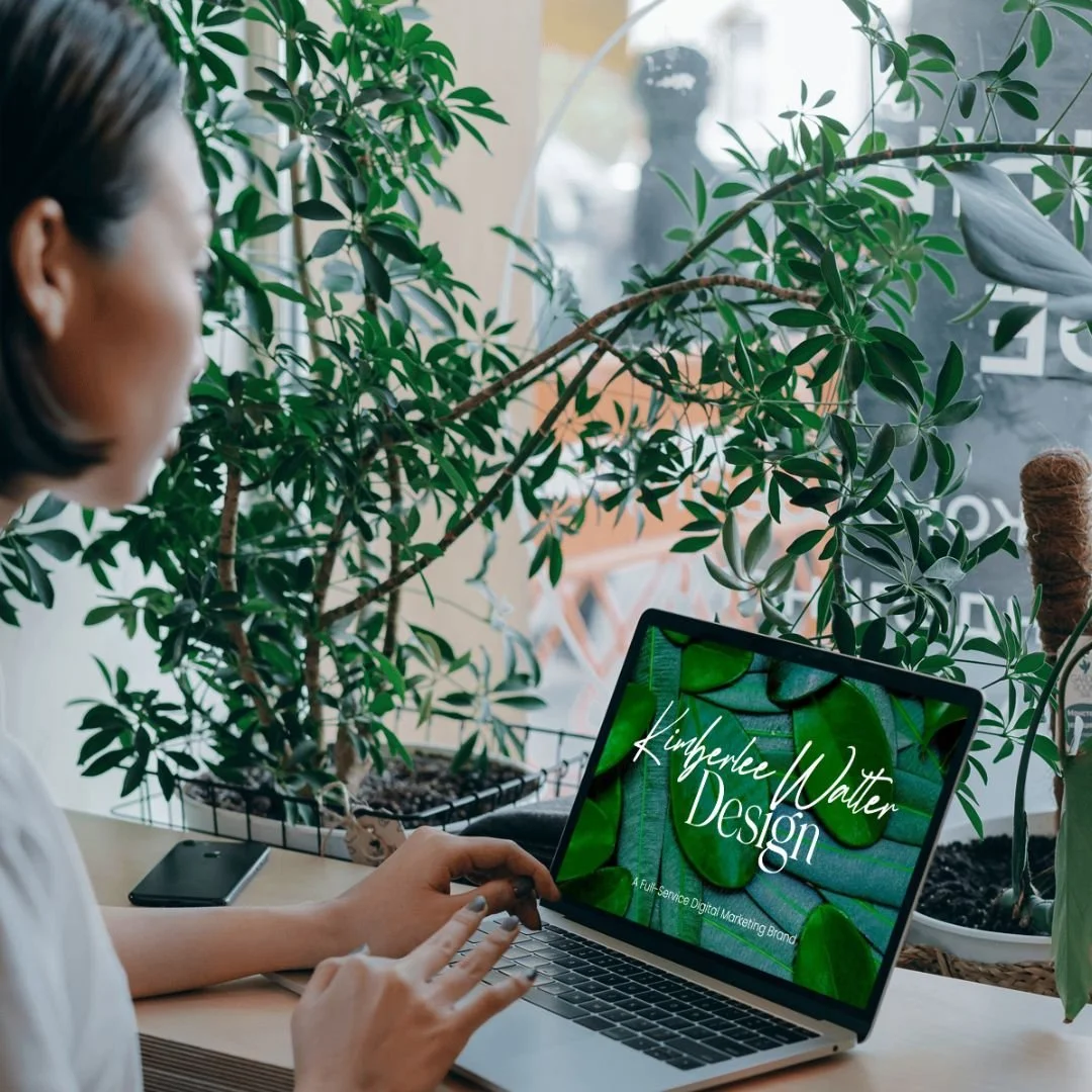 woman visits Kimberlee Walter Design on laptop
