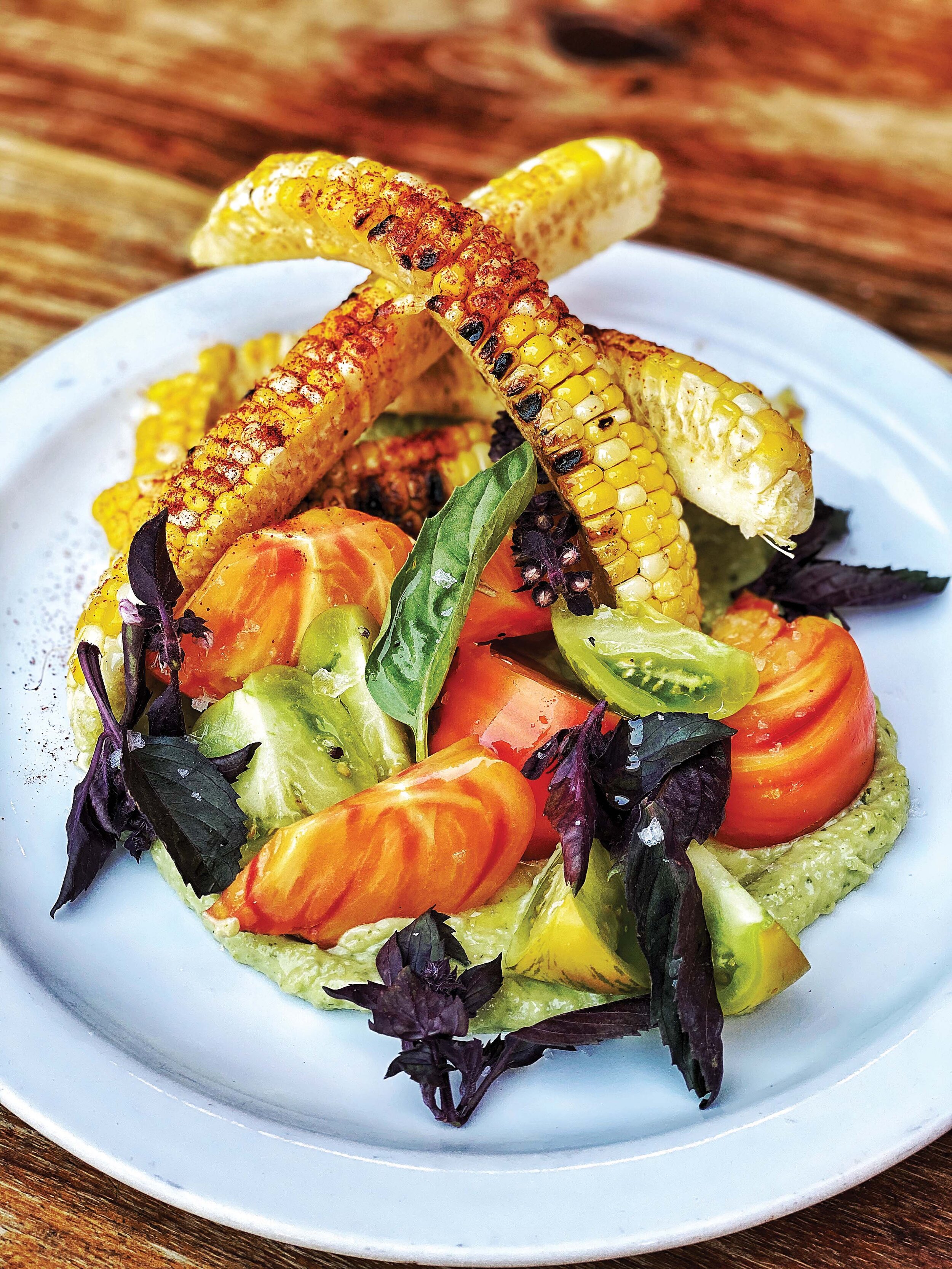  Staub's salad of grilled corn ribs and heirloom tomatoes, featuring Elder Flat Farm purple basil 