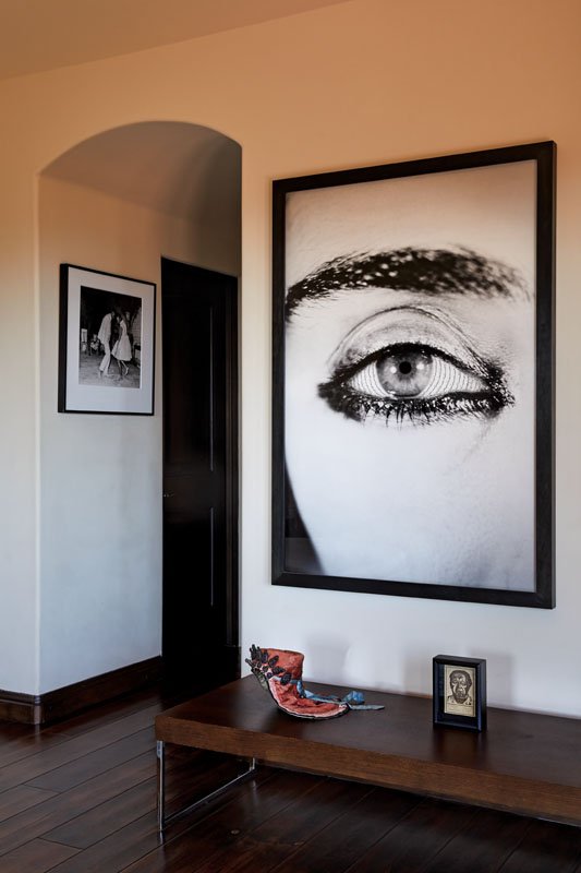  Iranian artist Shirin Neshat’s female-centric art casts a watchful gaze in the master bedroom. The photo on the left is by Malick Sidibé 