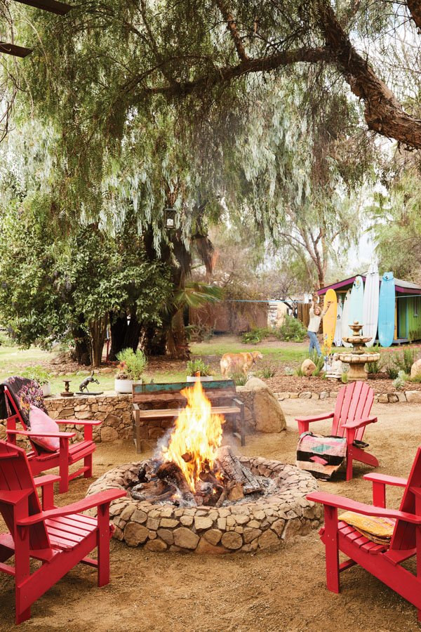  Beyond the fire pit at MaHarry’s eclectic Ojai residence, her son, Koda, works on his balance beside a barn for surfboards, the property’s latest addition.&nbsp; 